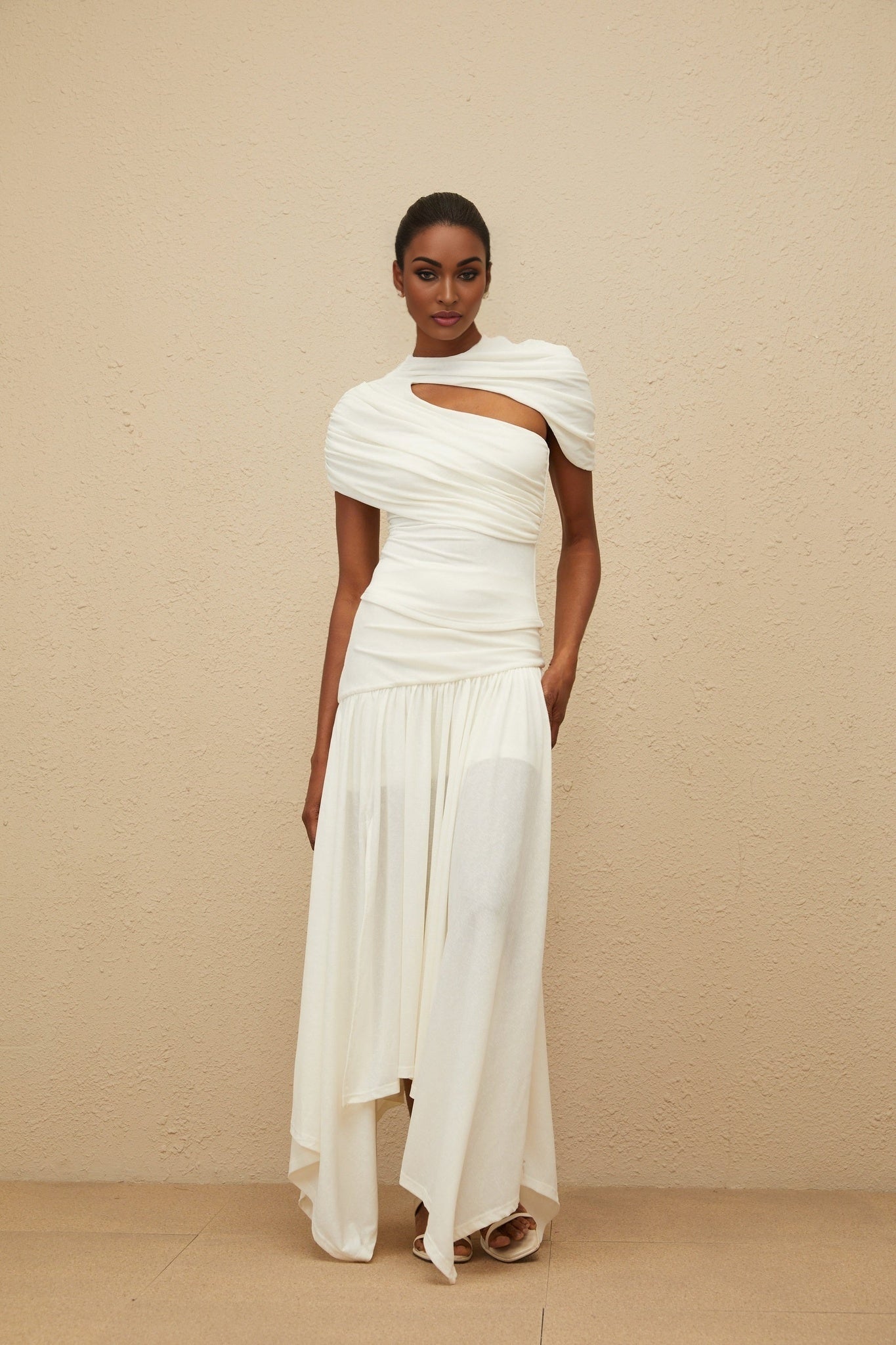 White fitted silhouette top and high rise skirt set with ruched detailing and asymmetrical design