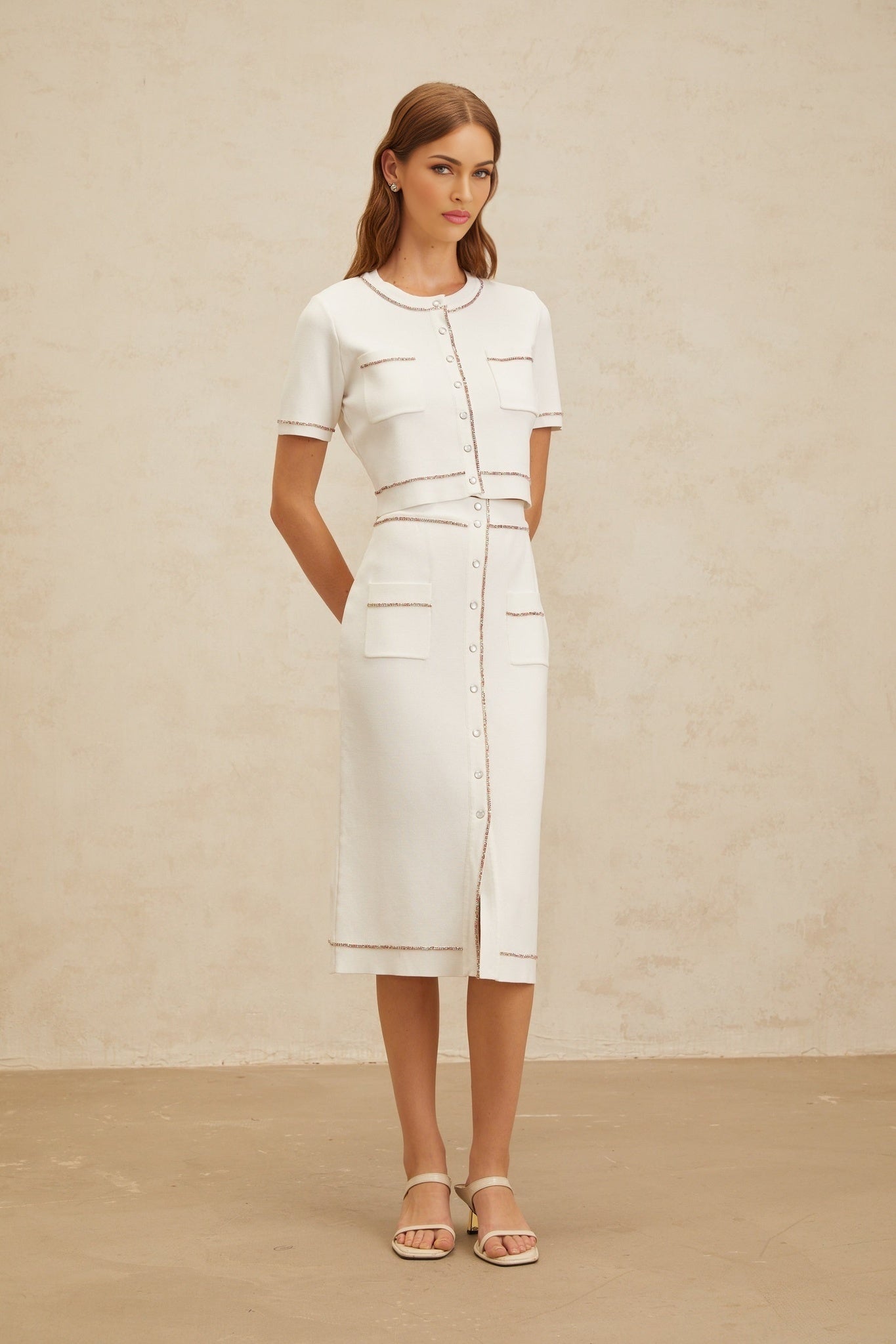 White knitted top and skirt set with crystal embellishment and patch pockets