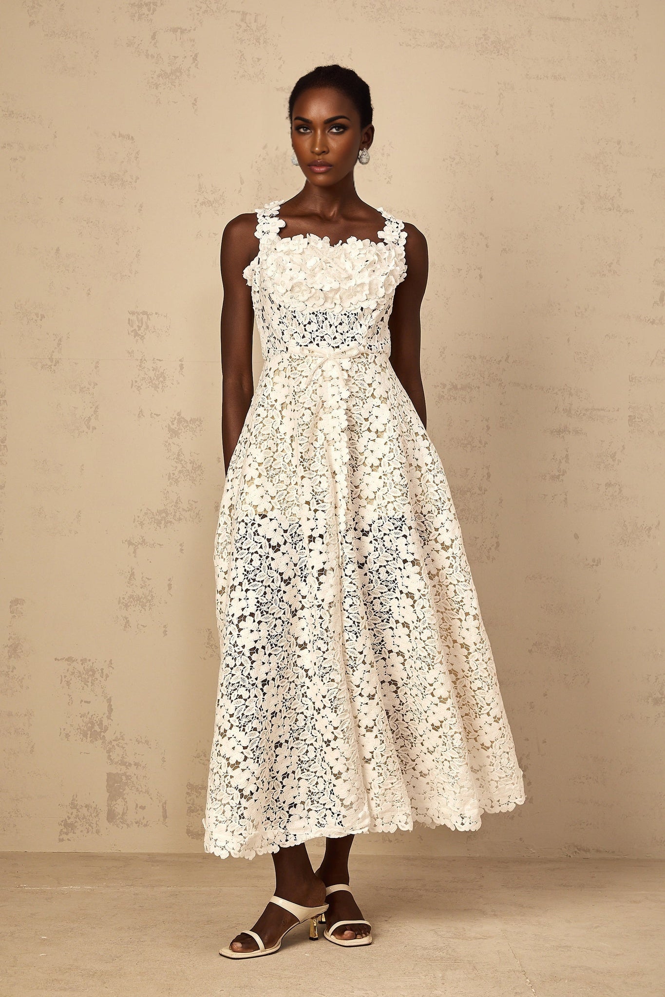 White lace maxi dress with shirred detailing and corded lace pattern on a female model