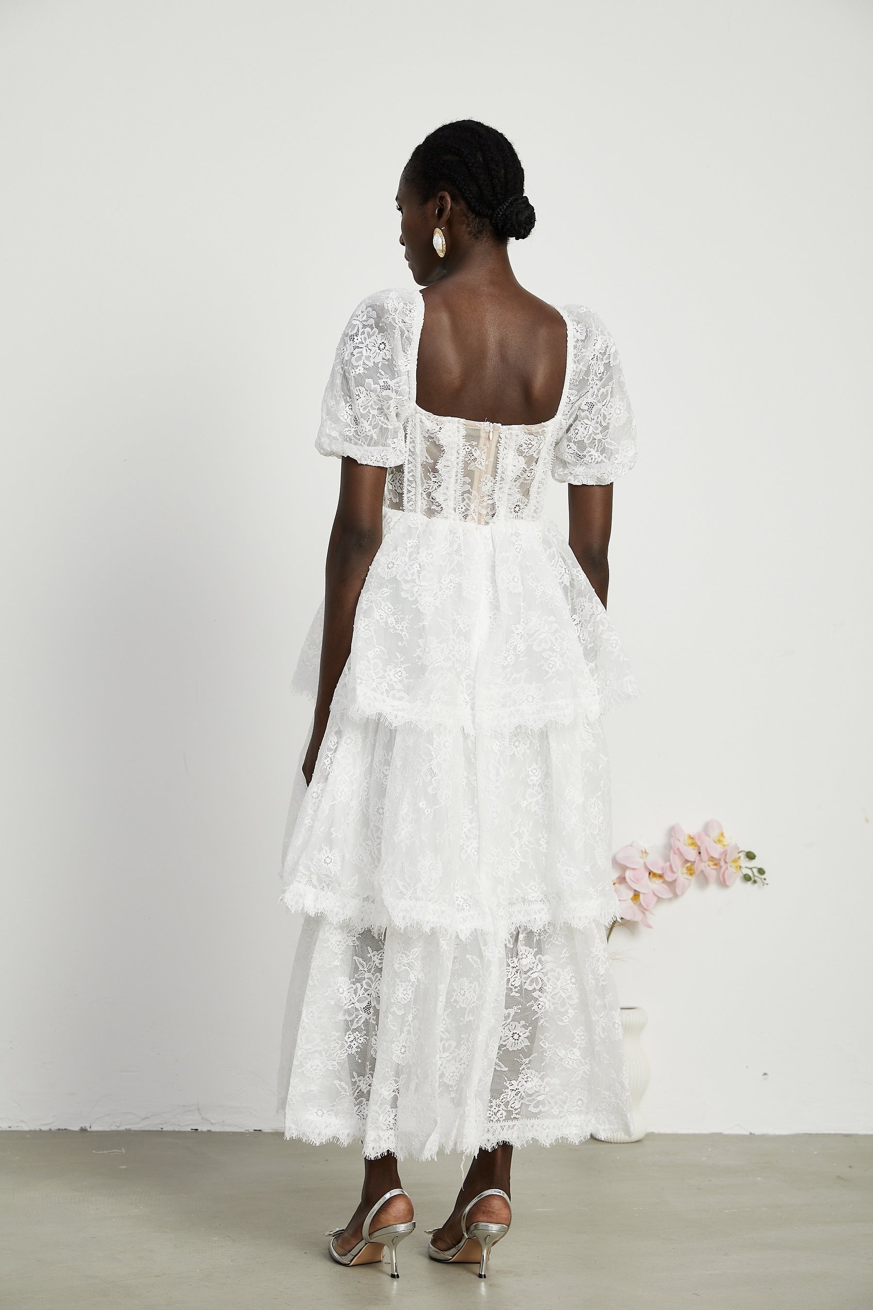 White lace midi dress with tiered layers by Melisande