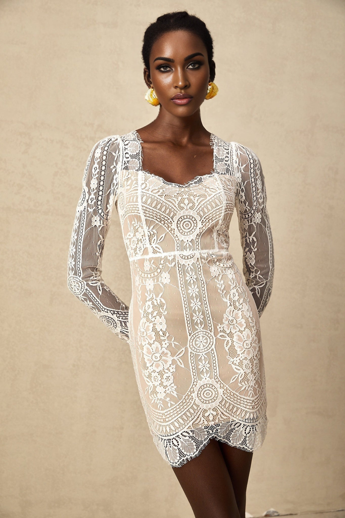 White lace mini dress with scalloped hem and delicate floral pattern