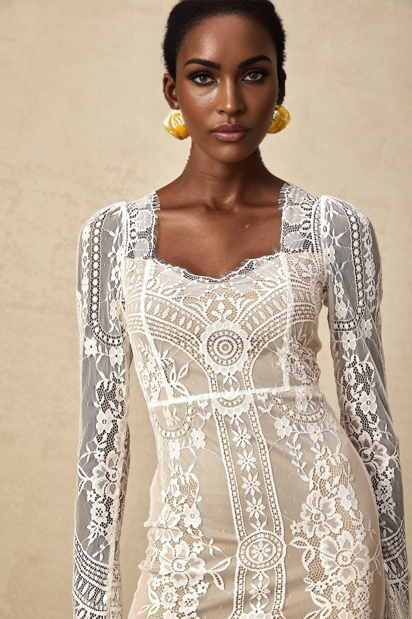 White lace mini dress with scalloped hem and intricate floral pattern