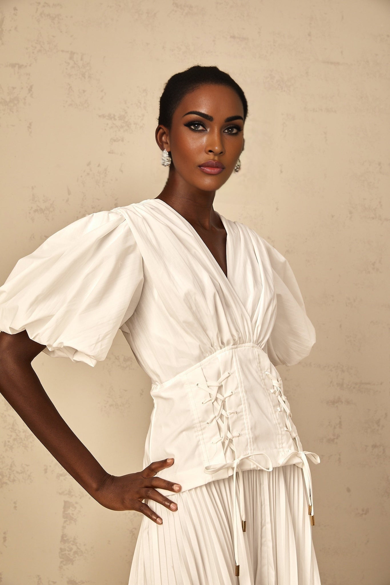 White lace up pleated maxi dress for women on plain background