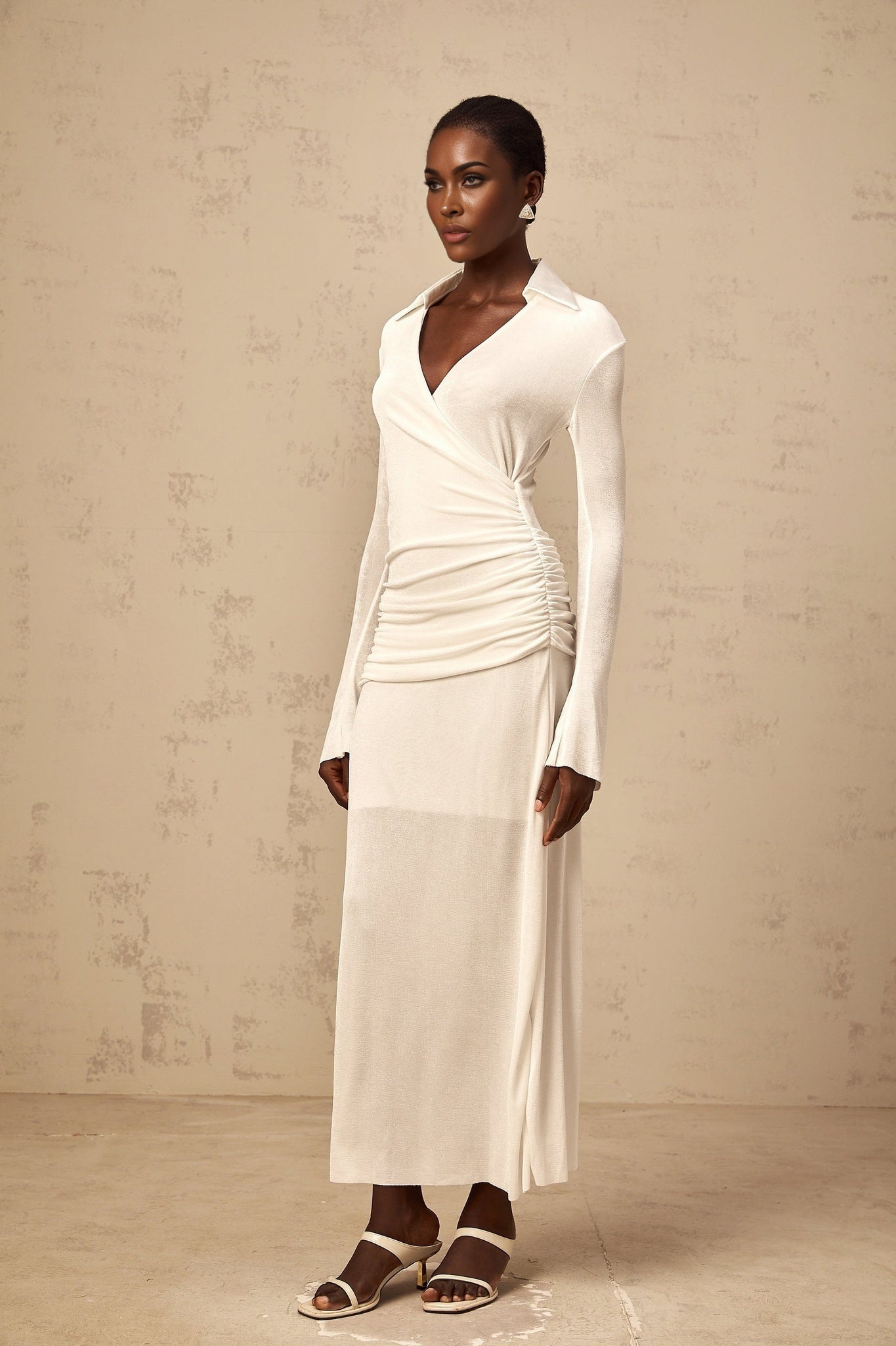 White long knit dress with ruched detailing and maxi length by Térébenthine