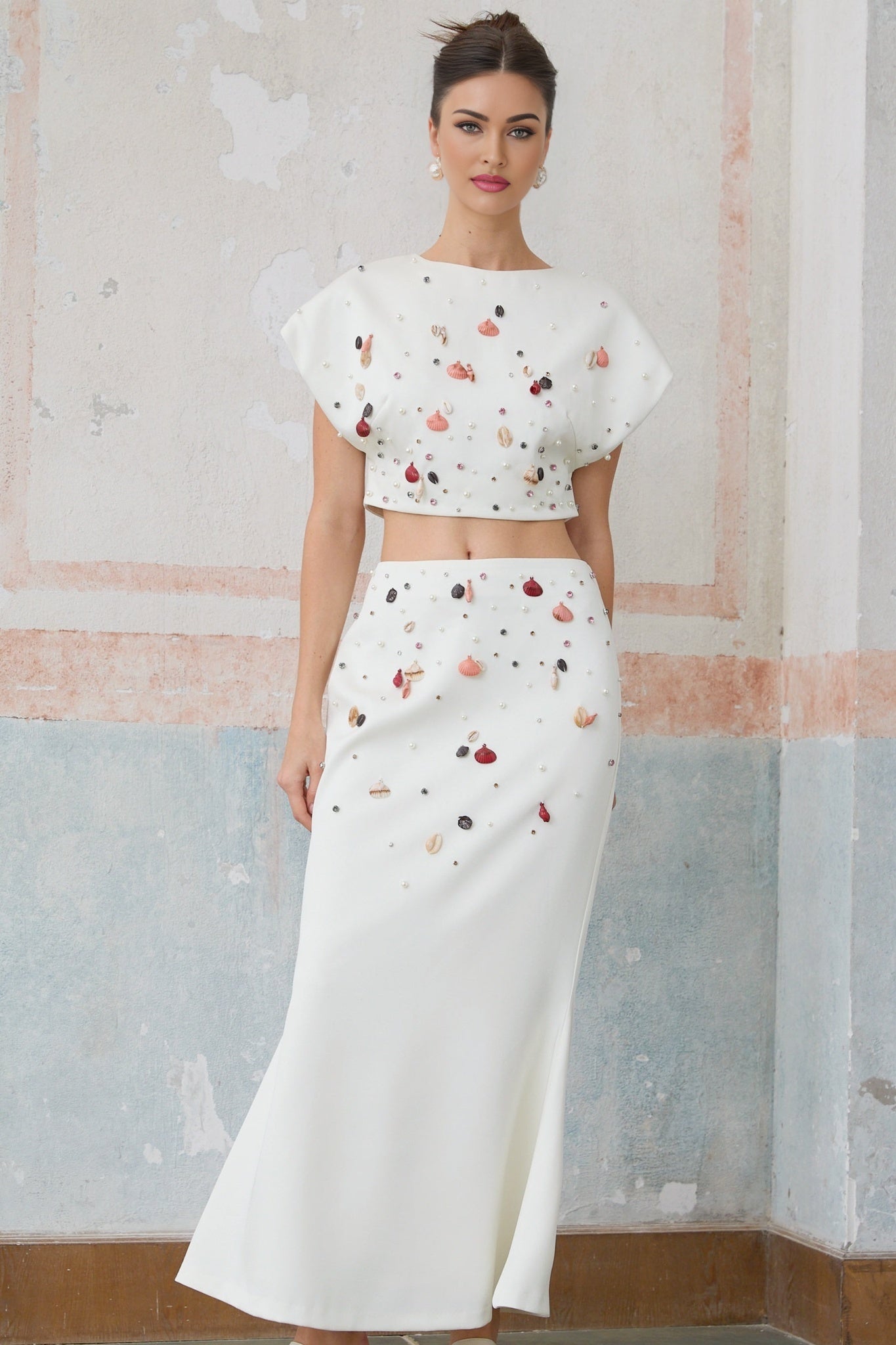 White matching set featuring a top and skirt adorned with shell embellishments named Delphine