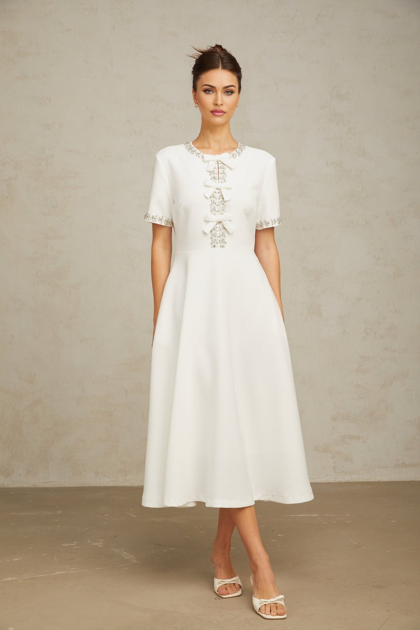 White midi dress with crystal accents and bow detail named Cassiopeia