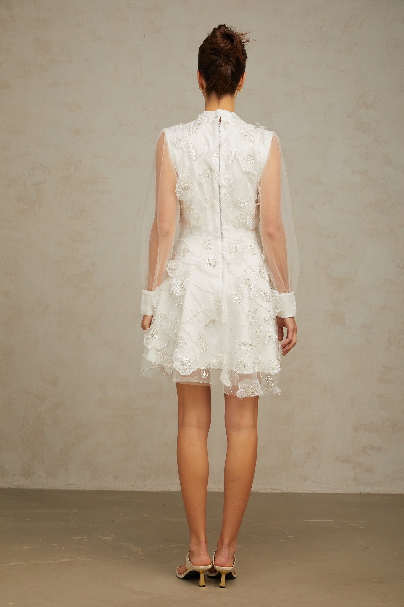 White mini dress with 3D floral petal details on tulle fabric named Camille