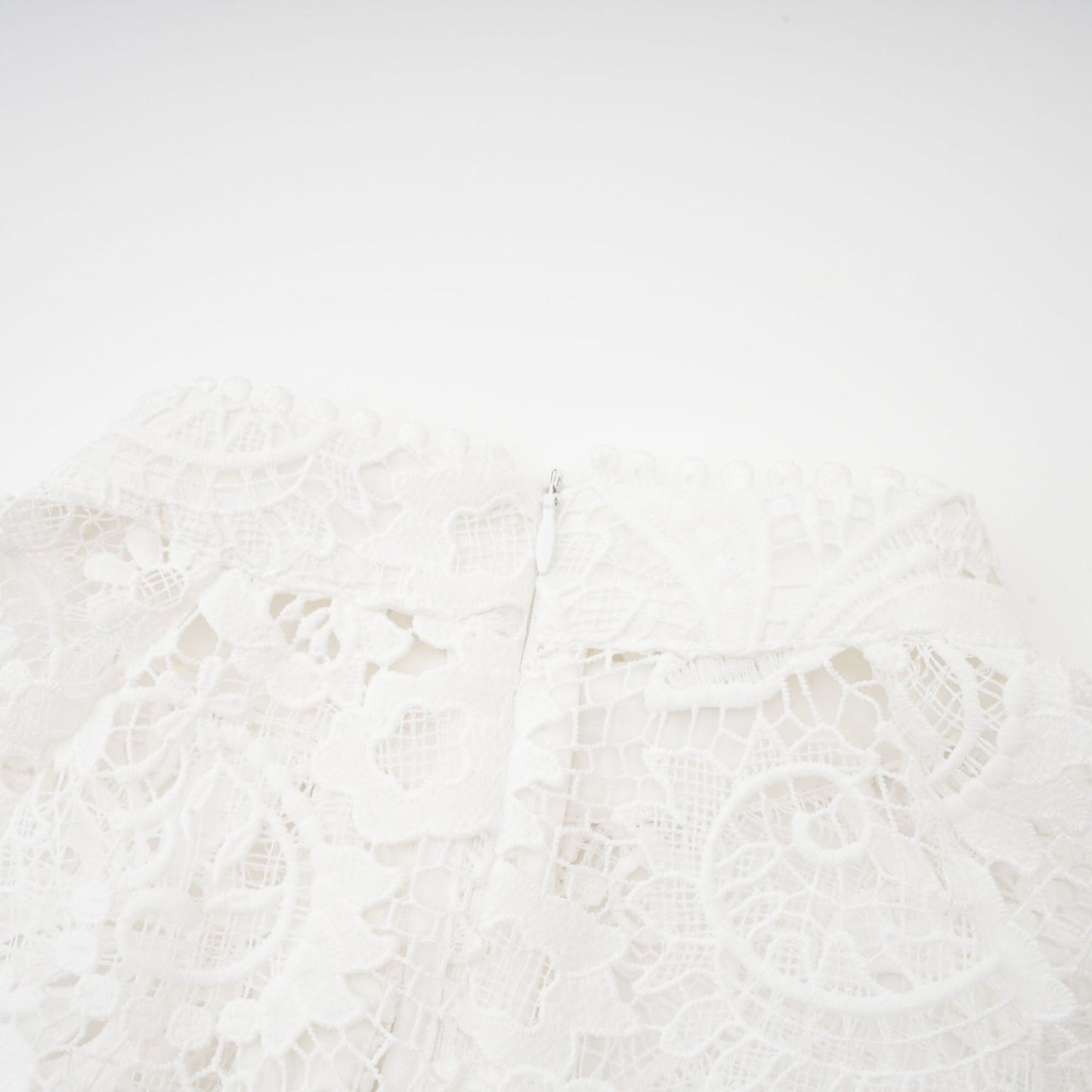 White Aline dress with embroidered lace detail cinched waist front button fastening and flounce hem