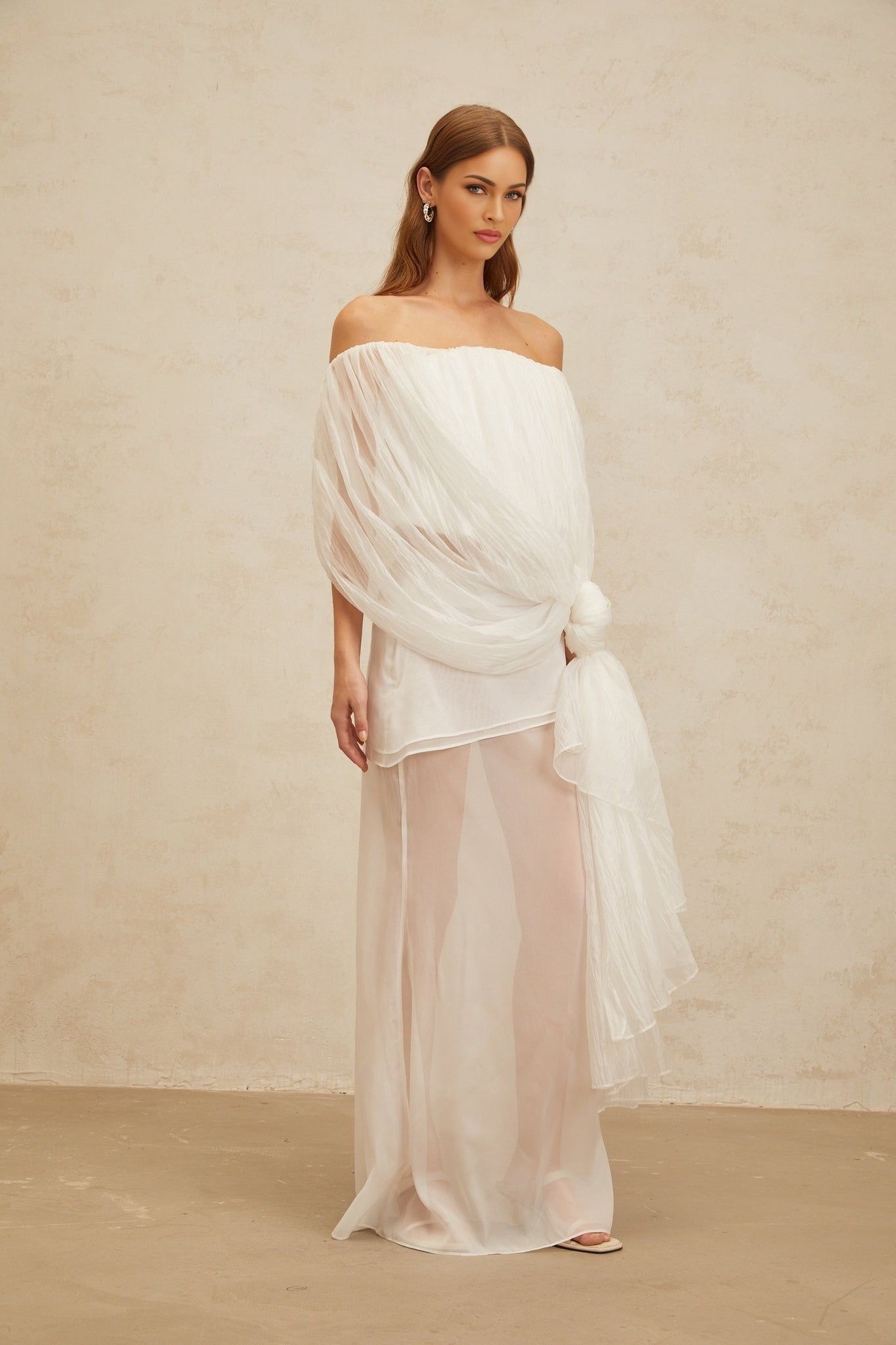 White off the shoulder sleeveless tulle top with twisted knot and asymmetrical design
