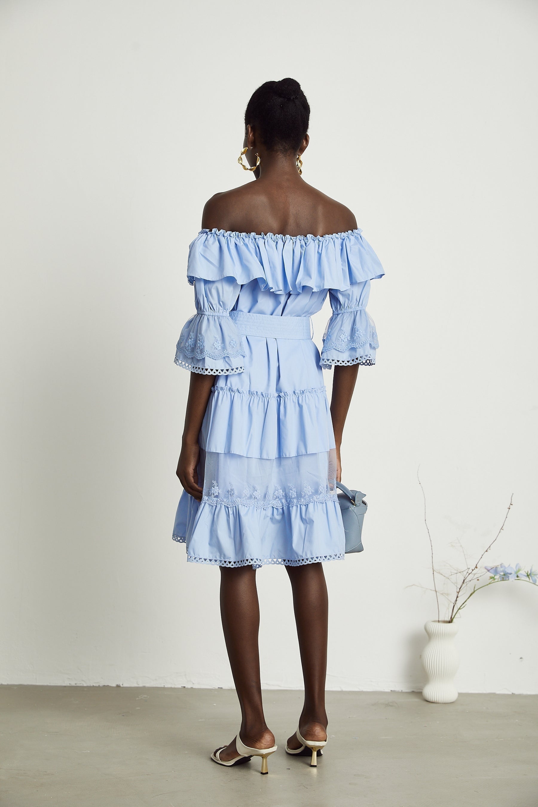 White offshoulder tiered midi dress with ruffled layers and elastic neckline