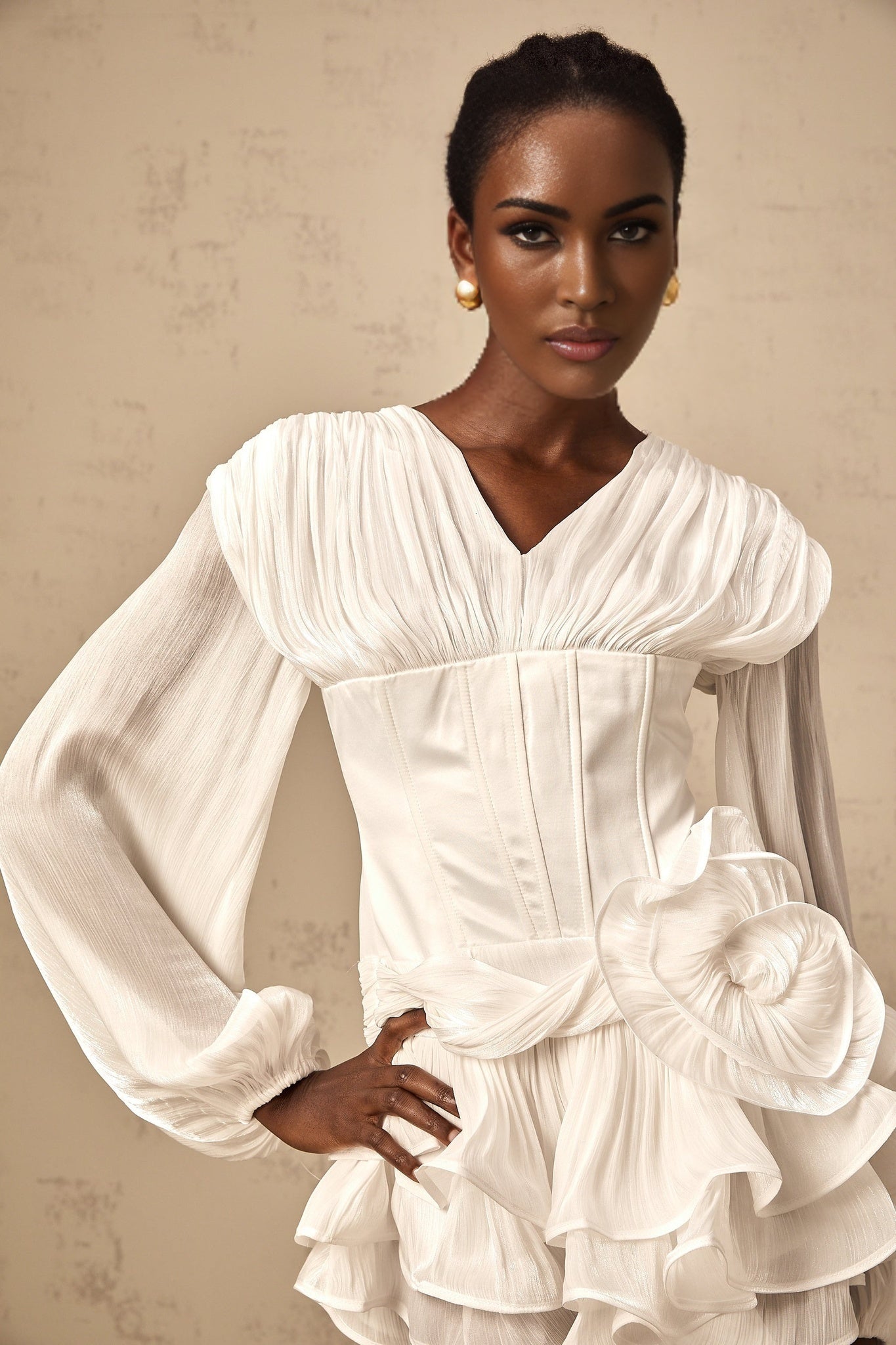 White pleated mini dress with cinched waist and full skirt