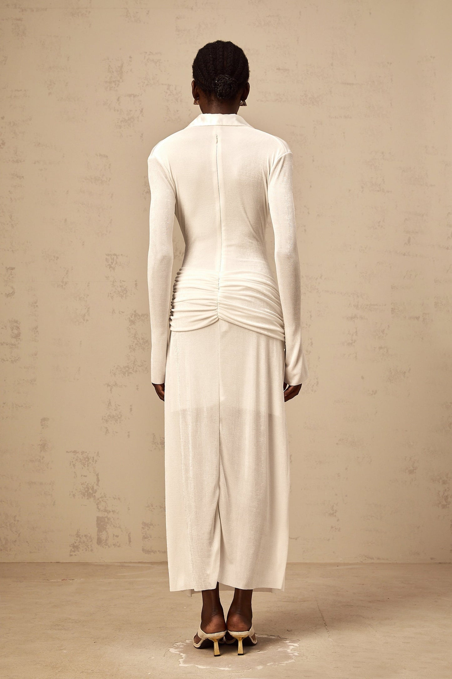 White ruched knit maxi dress with long sleeves and fitted silhouette