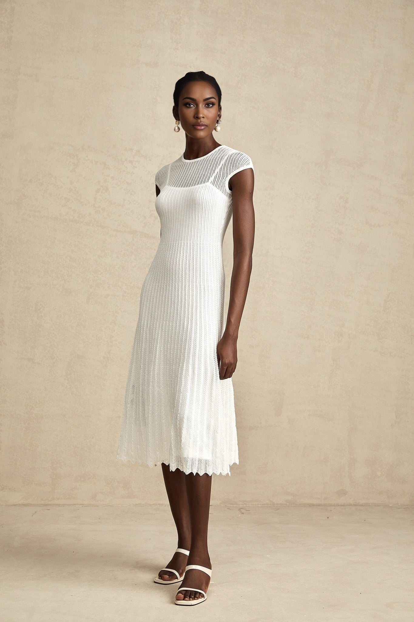 White semi sheer midi dress with scalloped hem called Liane