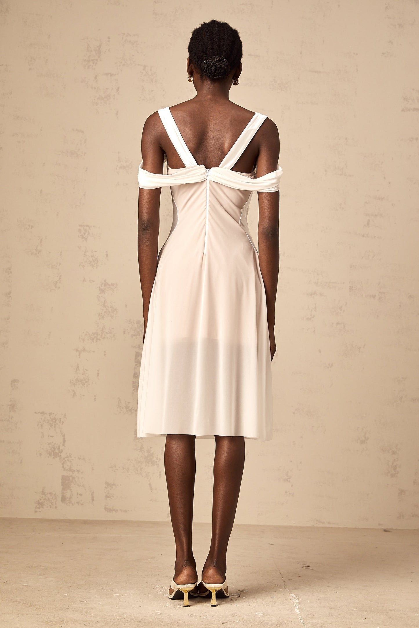 White semi sheer ruched midi dress on a mannequin or model