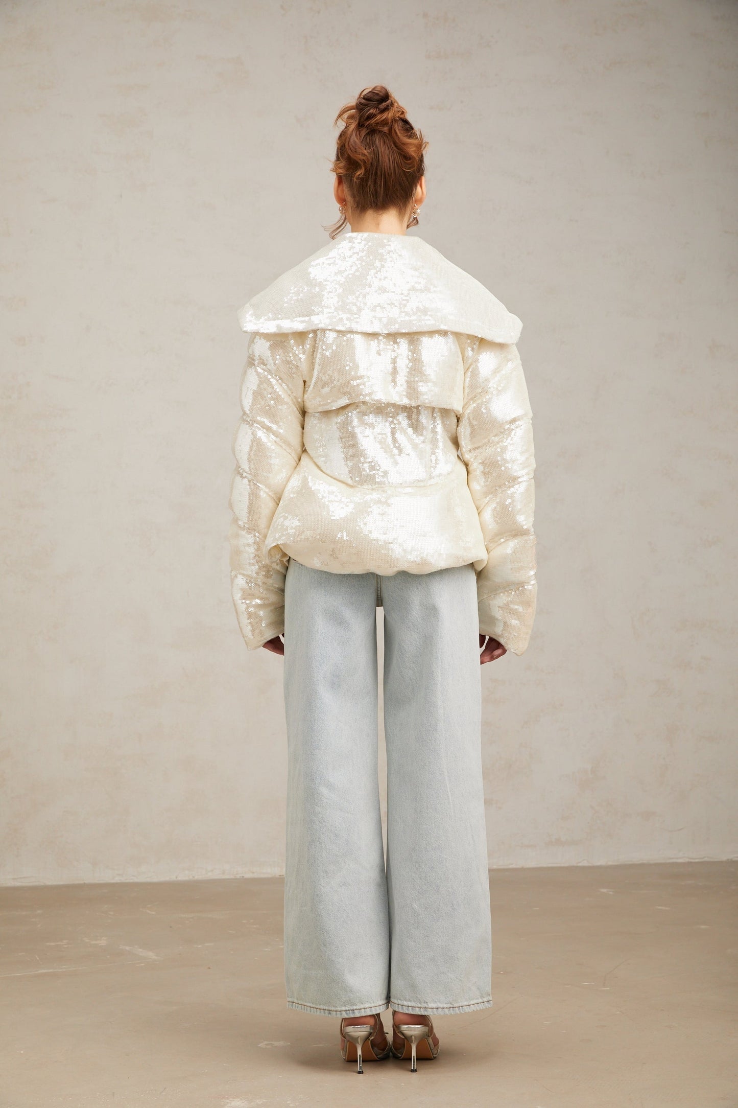 White sequined winter coat with down filling and long length featuring shiny embellishments