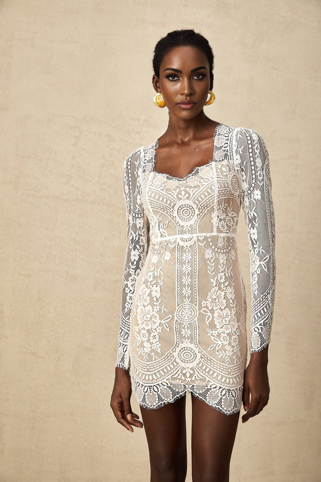 White short lace dress with scalloped hem and delicate floral pattern
