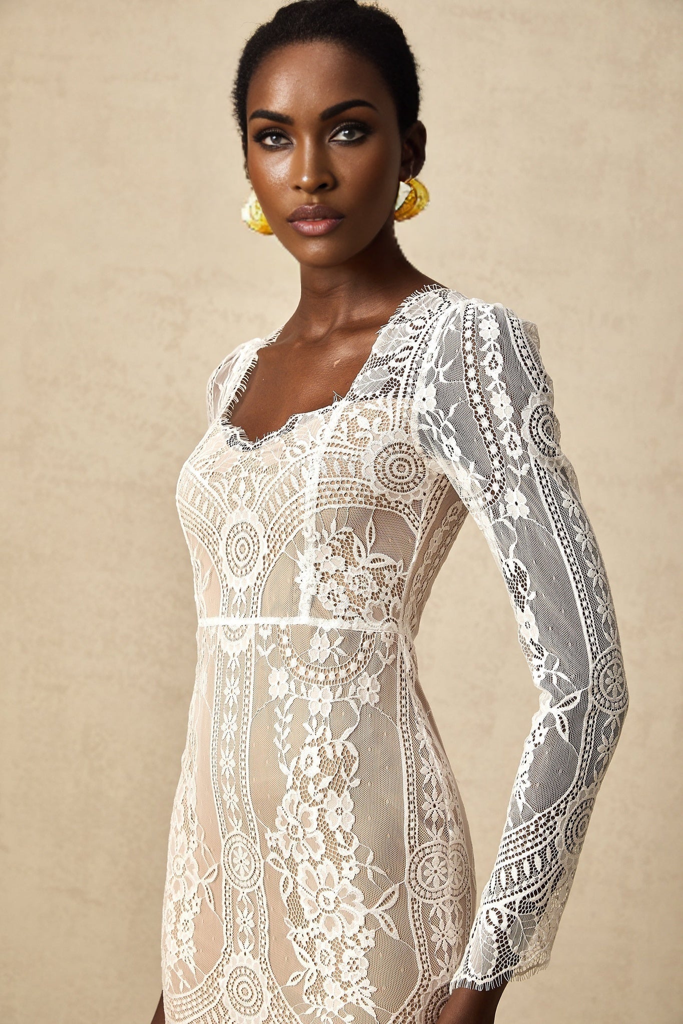 White short lace dress with scalloped hem and delicate floral pattern