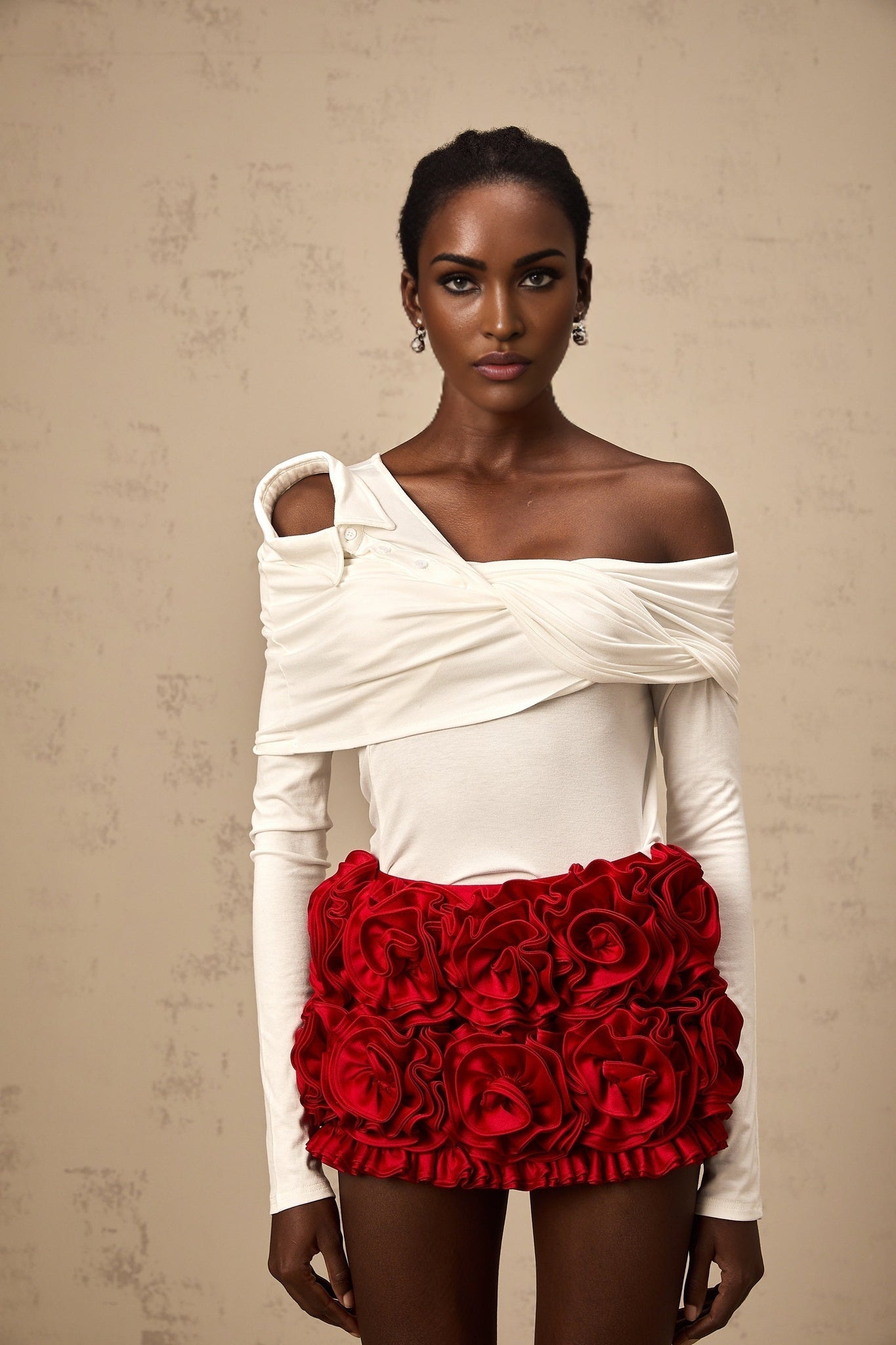 White sleeveless jersey top with asymmetric neckline and twisted fabric detail