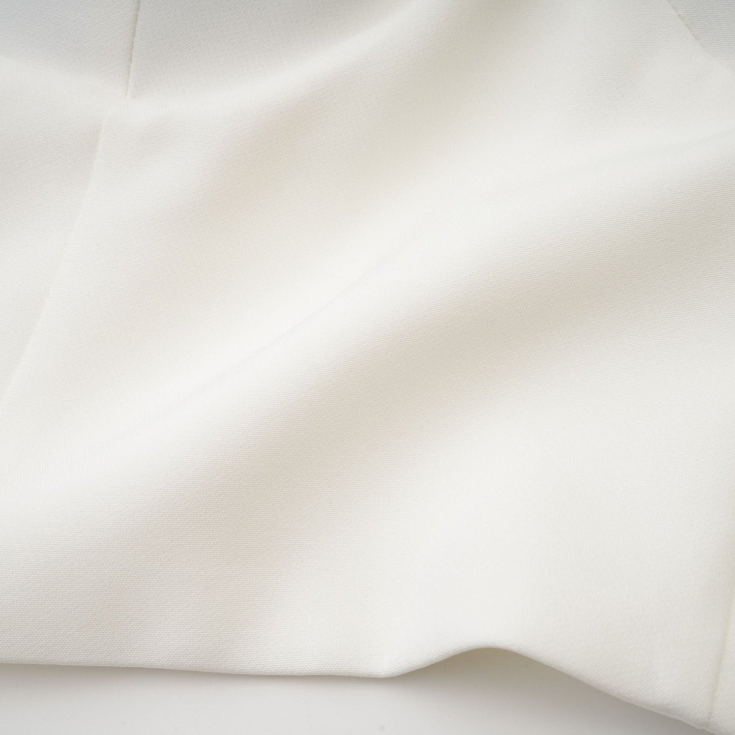 White sleeveless top with floral applique details named Lucie