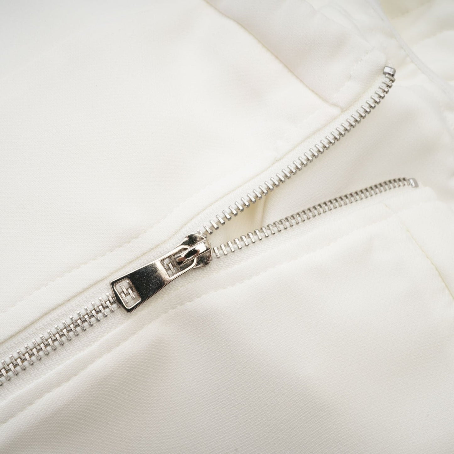White sleeveless top with floral applique details named Lucie