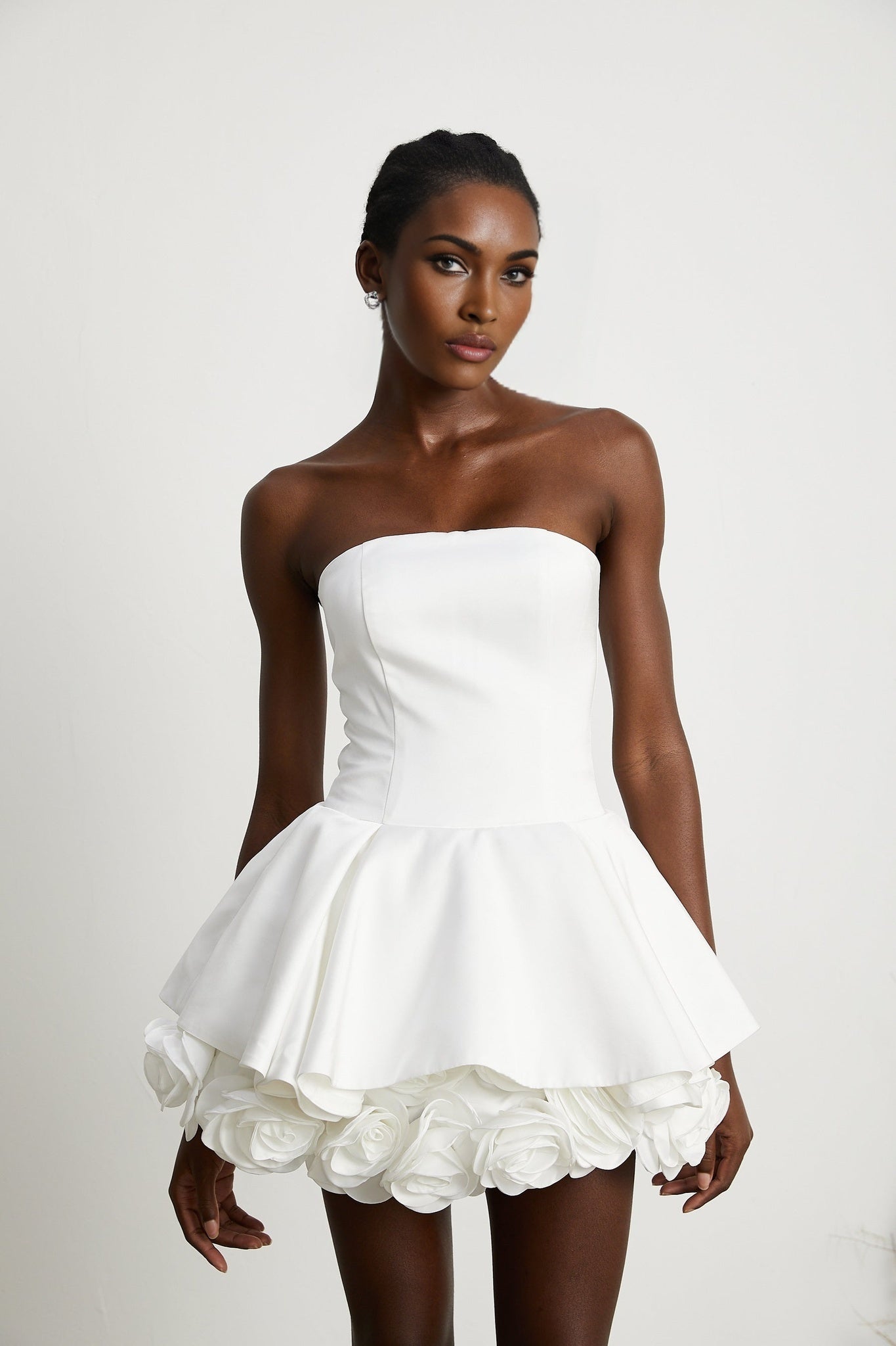 White strapless mini dress with corset style bodice and floral petal details