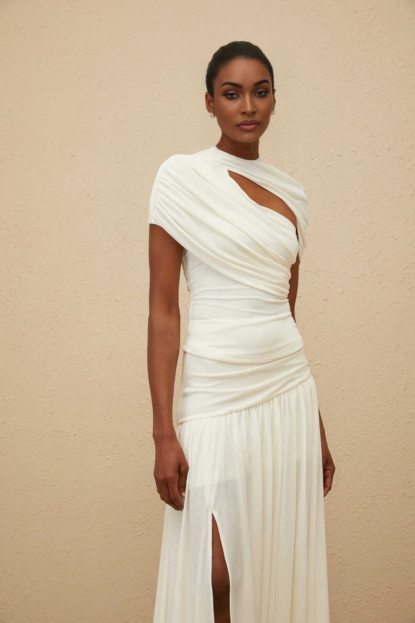 White stretch round neck fitted silhouette top and high rise maxi length skirt set with ruched detailing and asymmetrical design