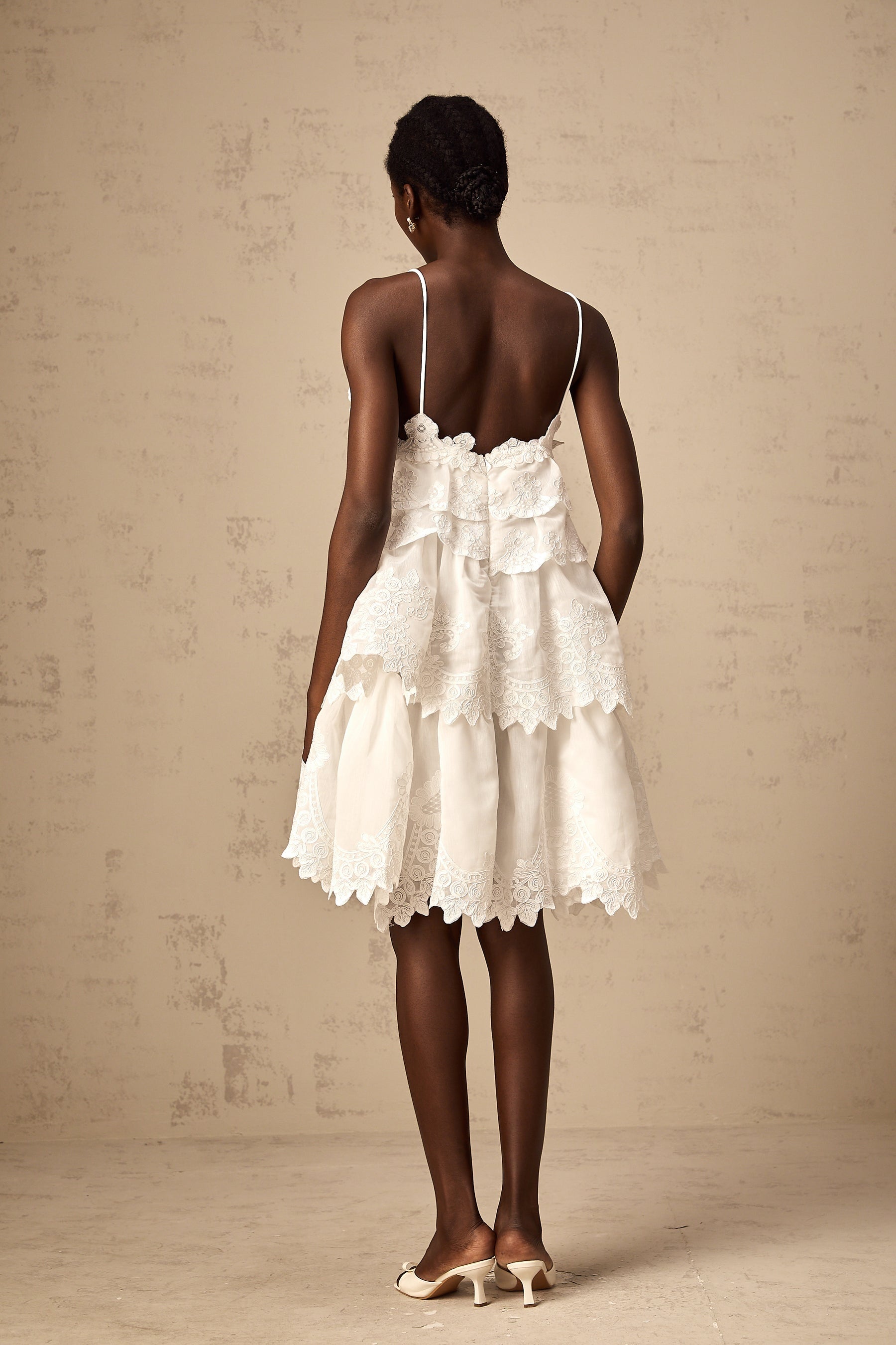 White tiered mini dress with guipure lace details named Valeria