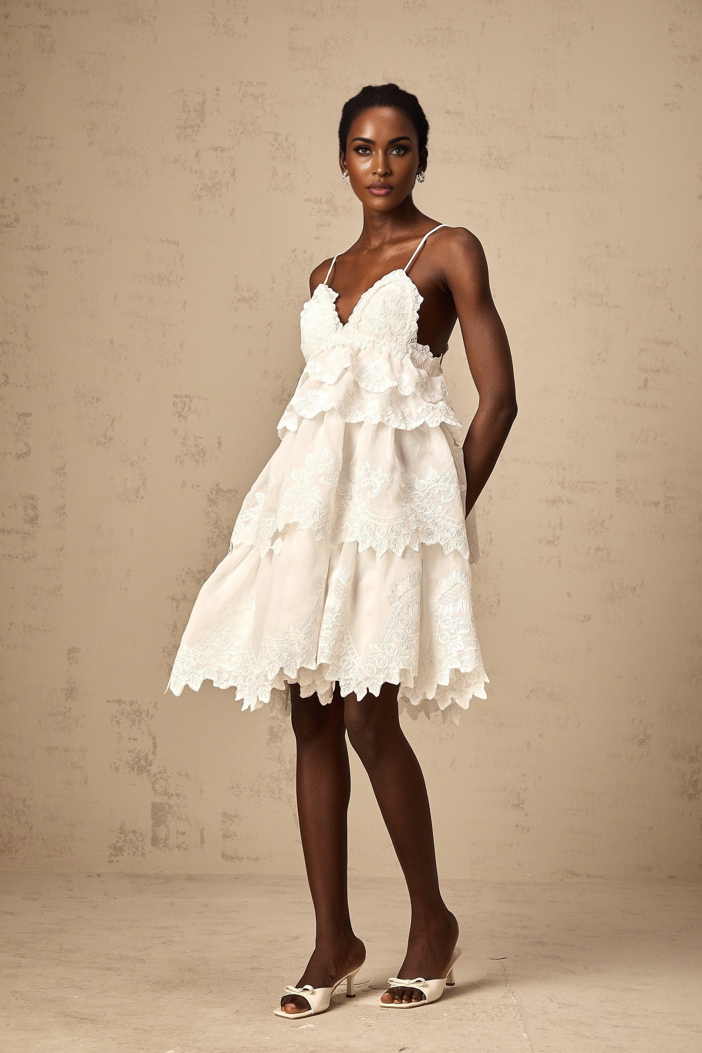 White tiered mini dress with guipure lace details named Valeria
