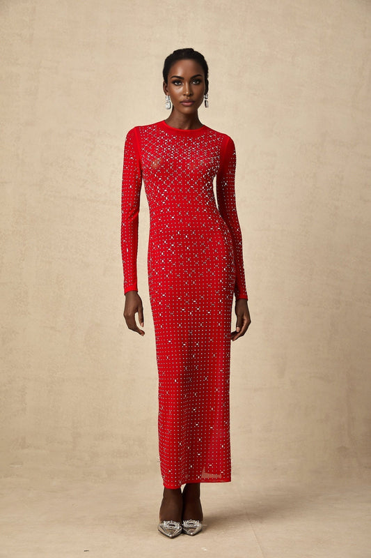 Woman in flowing red tulle maxi dress adorned with sparkling rhinestones