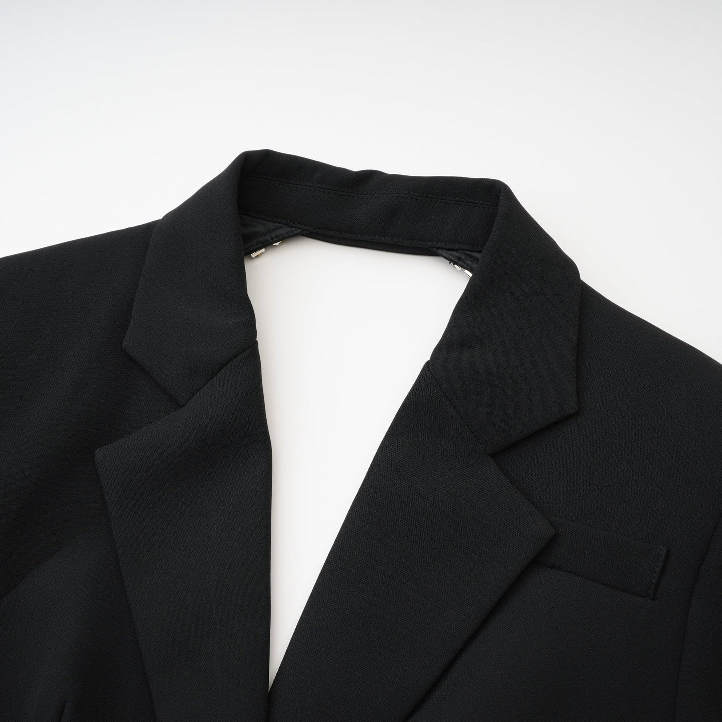 Black dress with long sleeves notched lapels scoop back and buttoned cuffs fitte% waistline and crystal embellishment Button fastening on the front Made of 100% Polyester