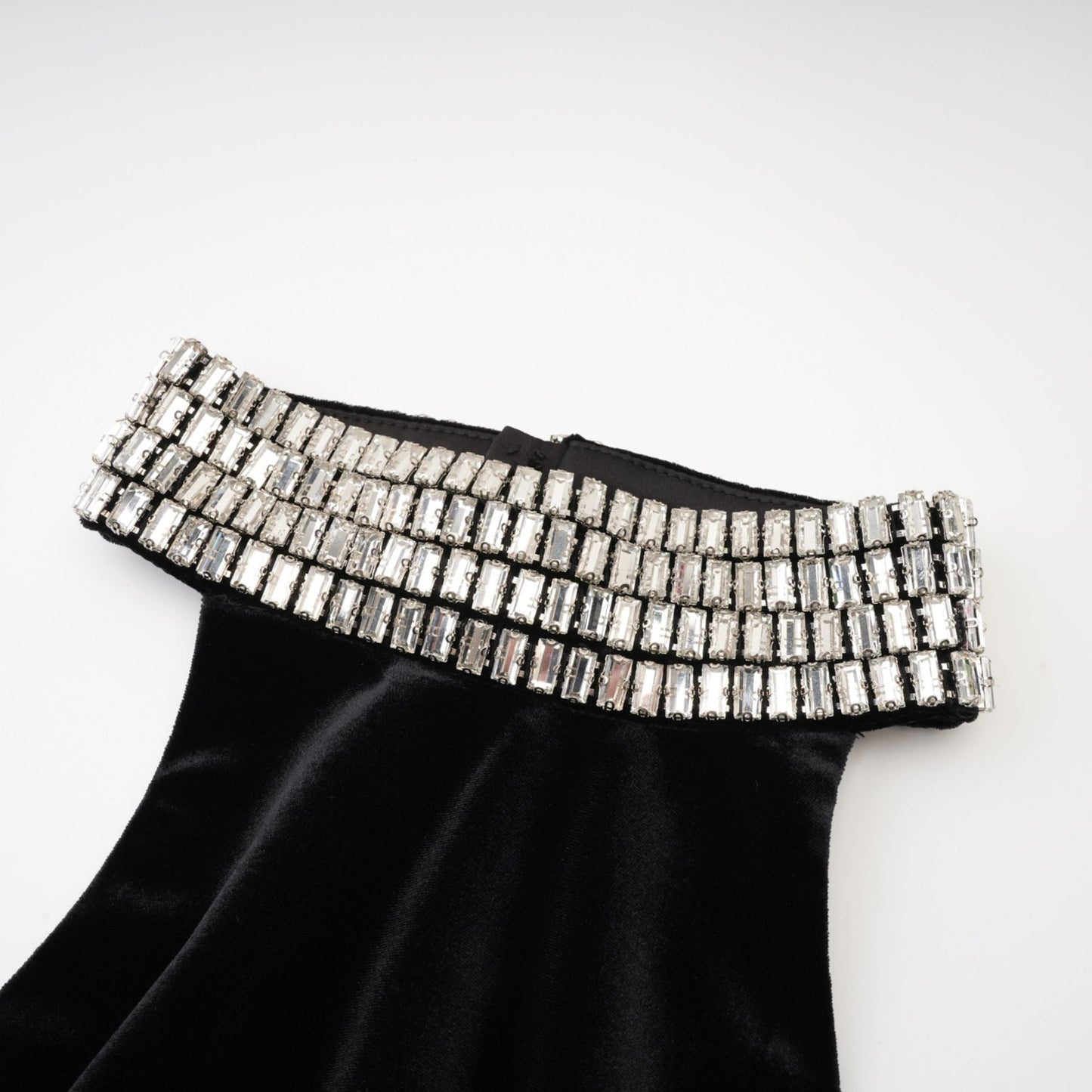 Sleeveless black dress with embellished crystal turtle neck ankle length rear zip fastening and side slit Made of 100% Polyester