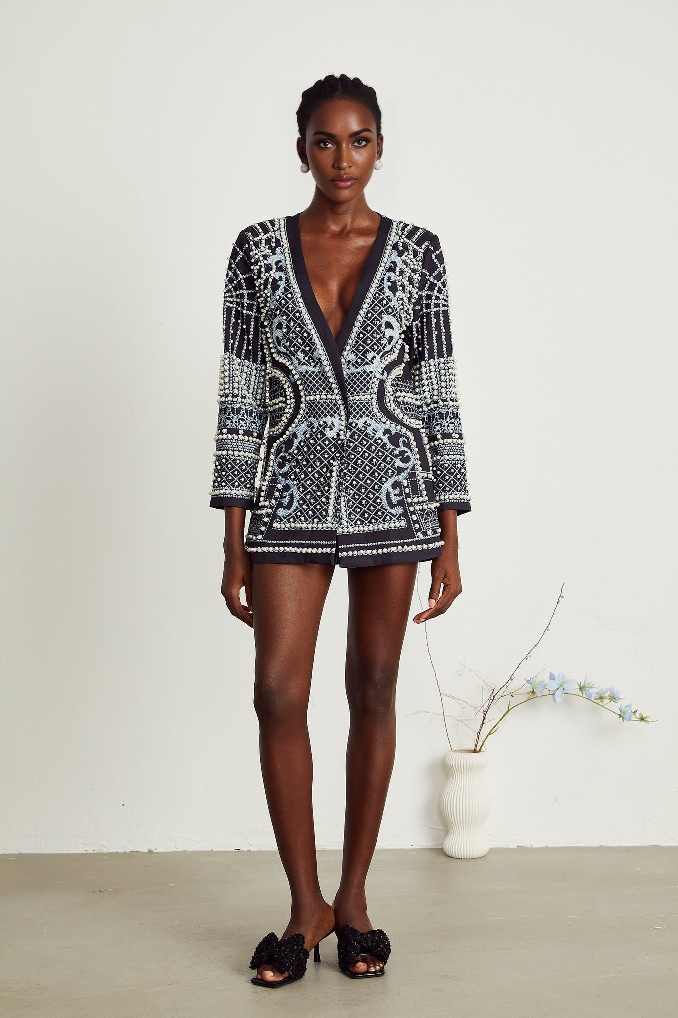 Woman wearing a blazer dress with Catherine pattern print and Vneck design