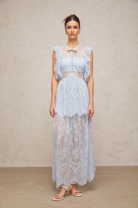Woman wearing a blue lace maxi dress with layered skirt and capucine style neckline