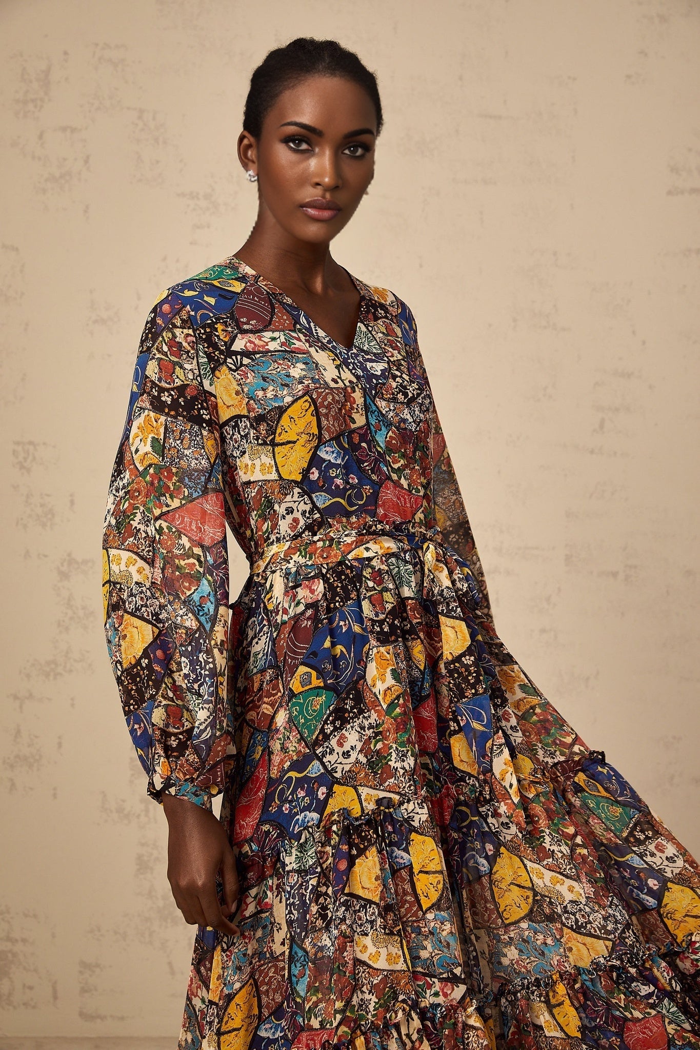 Woman wearing a brown bohemian style midi dress with shirring detail and flowing fabric