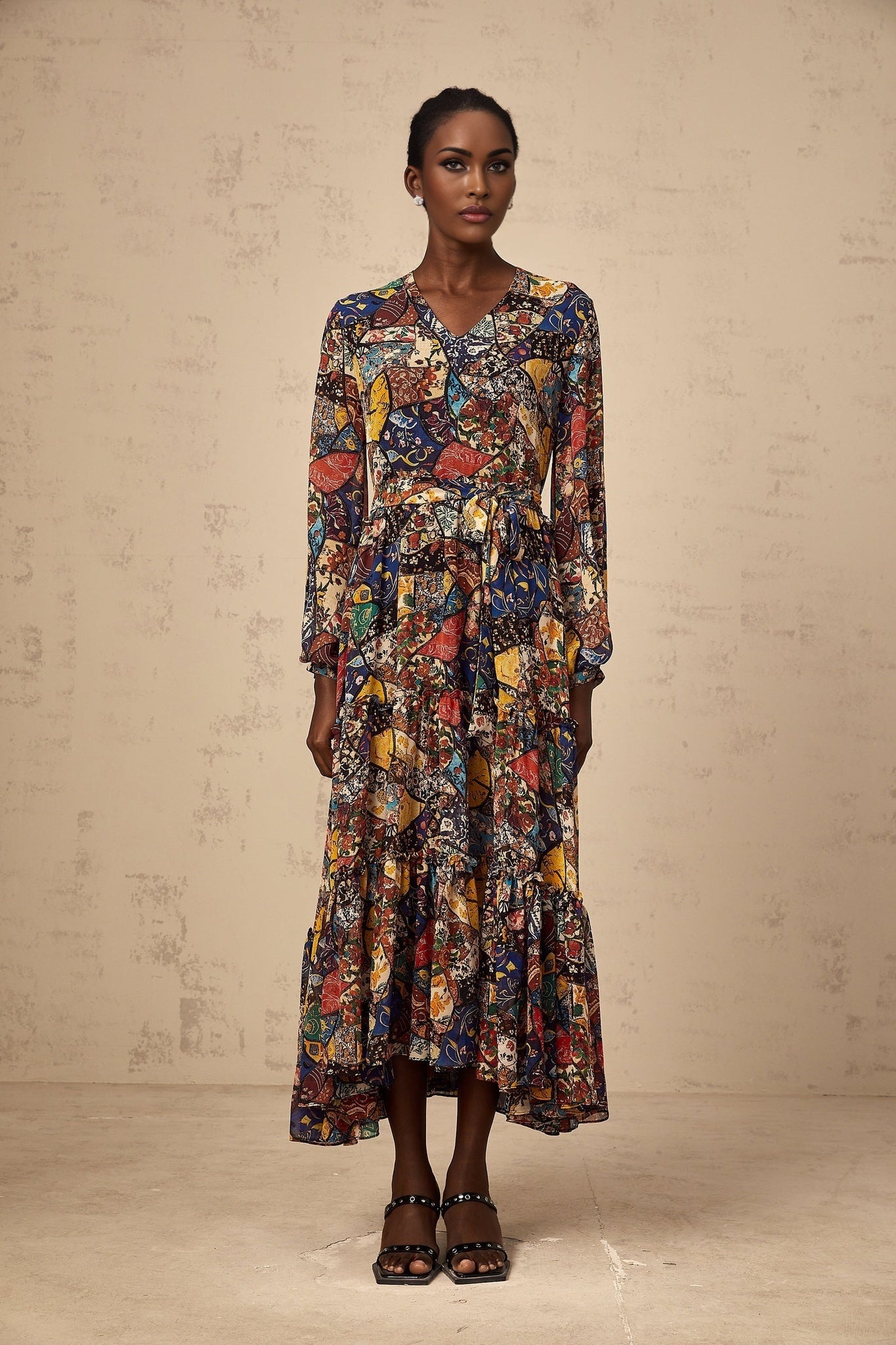 Woman wearing a brown bohemian style midi dress with shirring detail and flowing skirt