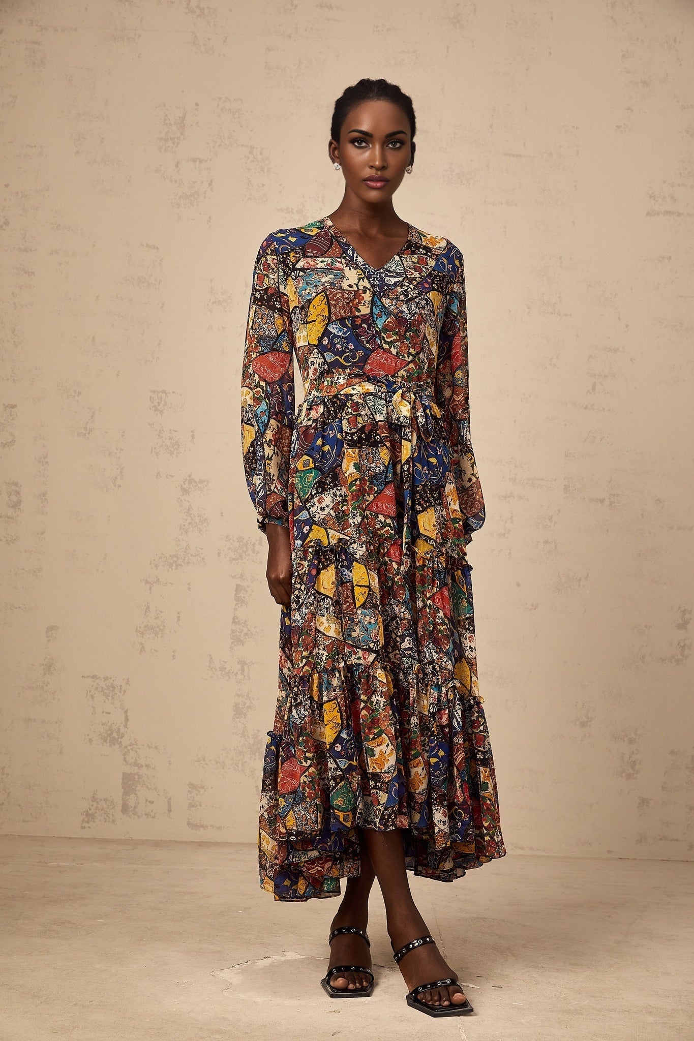 Woman wearing a brown bohemian style midi dress with shirring detail