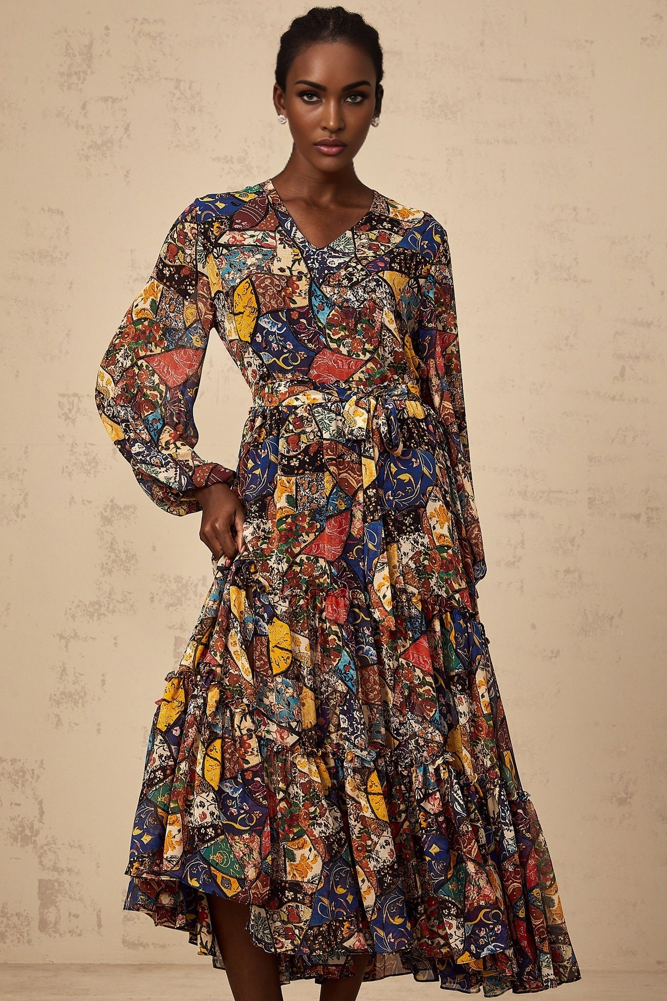 Woman wearing a brown bohemian style midi dress with shirring details and flowing fabric