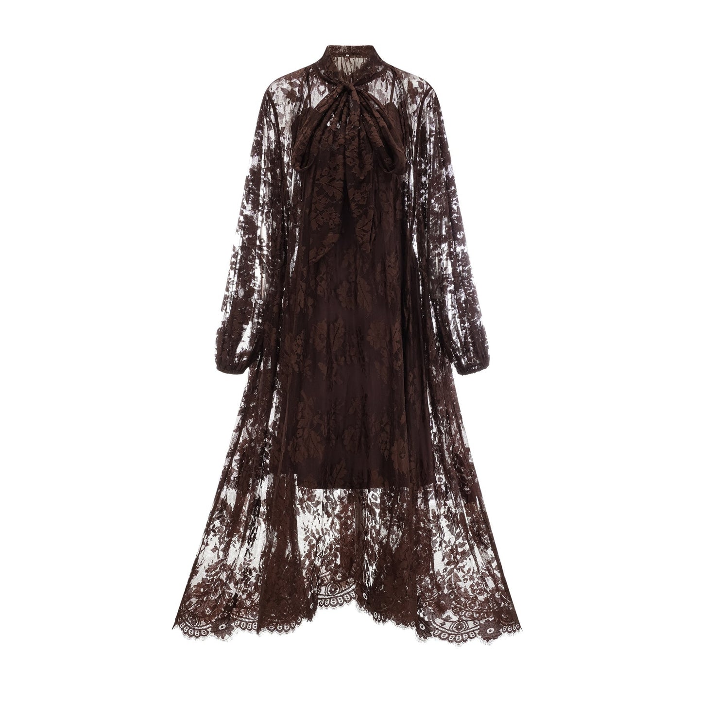 Woman wearing a brown flared midi dress made of chantilly lace with a fitted bodice and flowy skirt standing in a neutral background