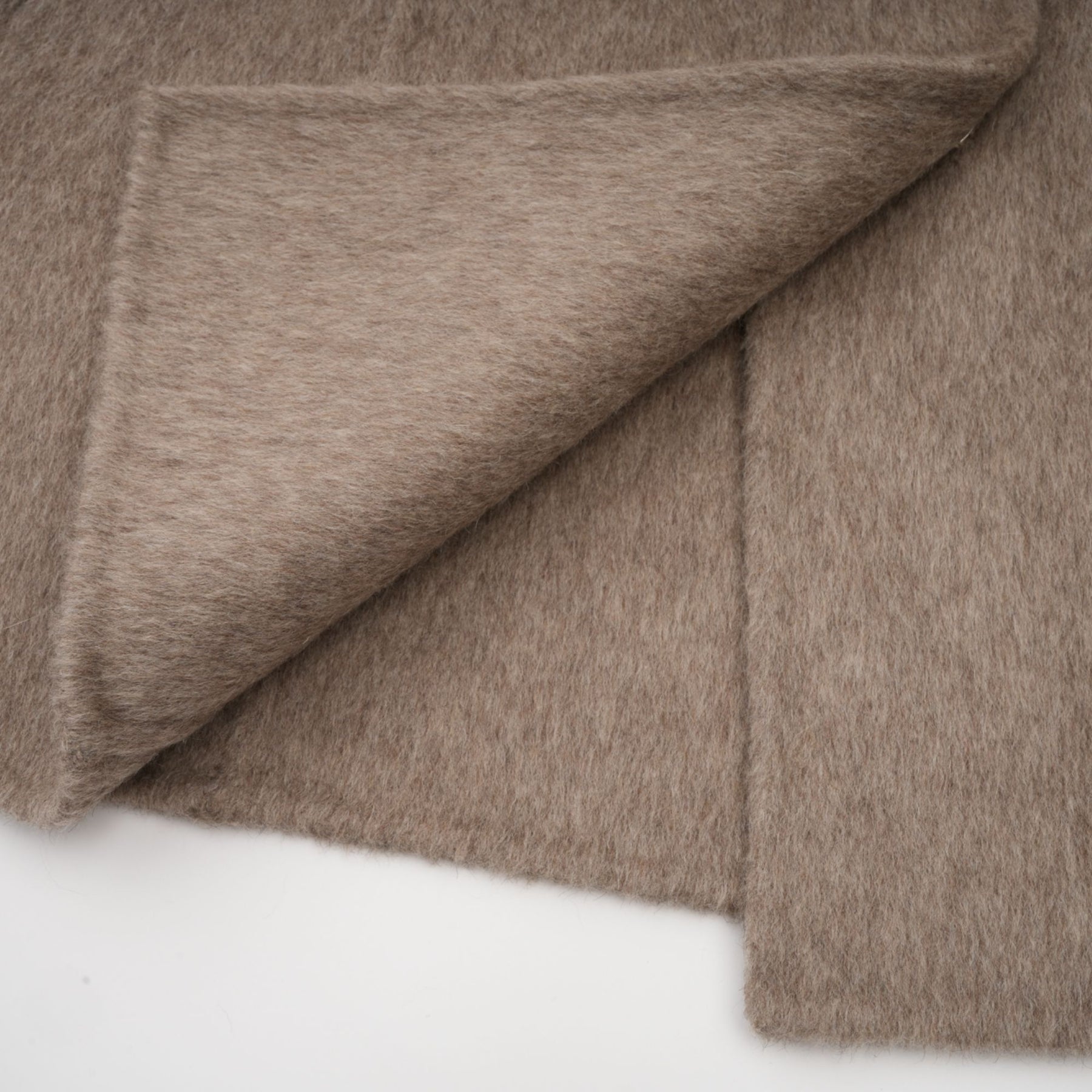 Woman wearing a brown wool cape coat with fur trim and belt