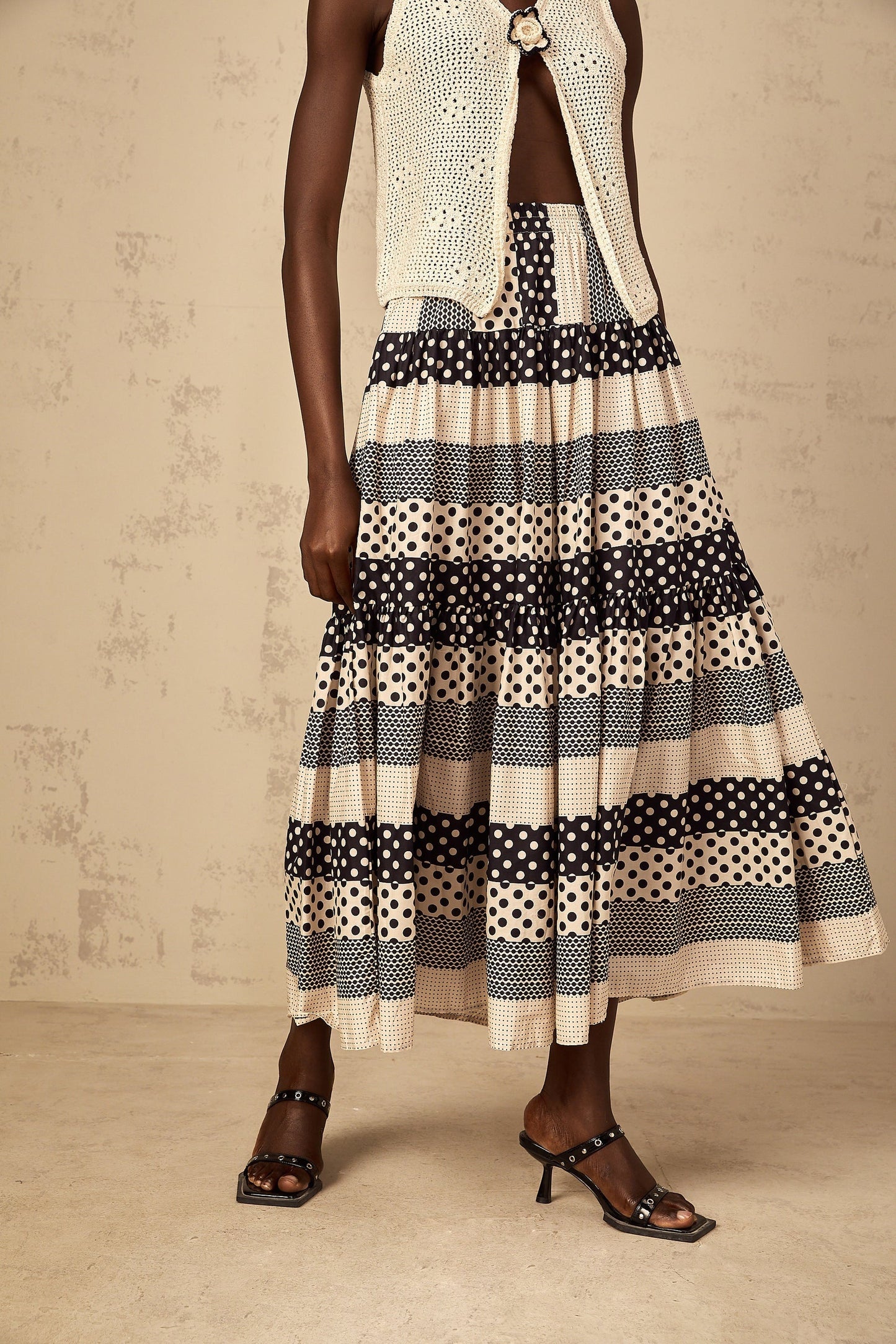 Woman wearing a colorblock skirt with polka dot pattern and shirred waistline