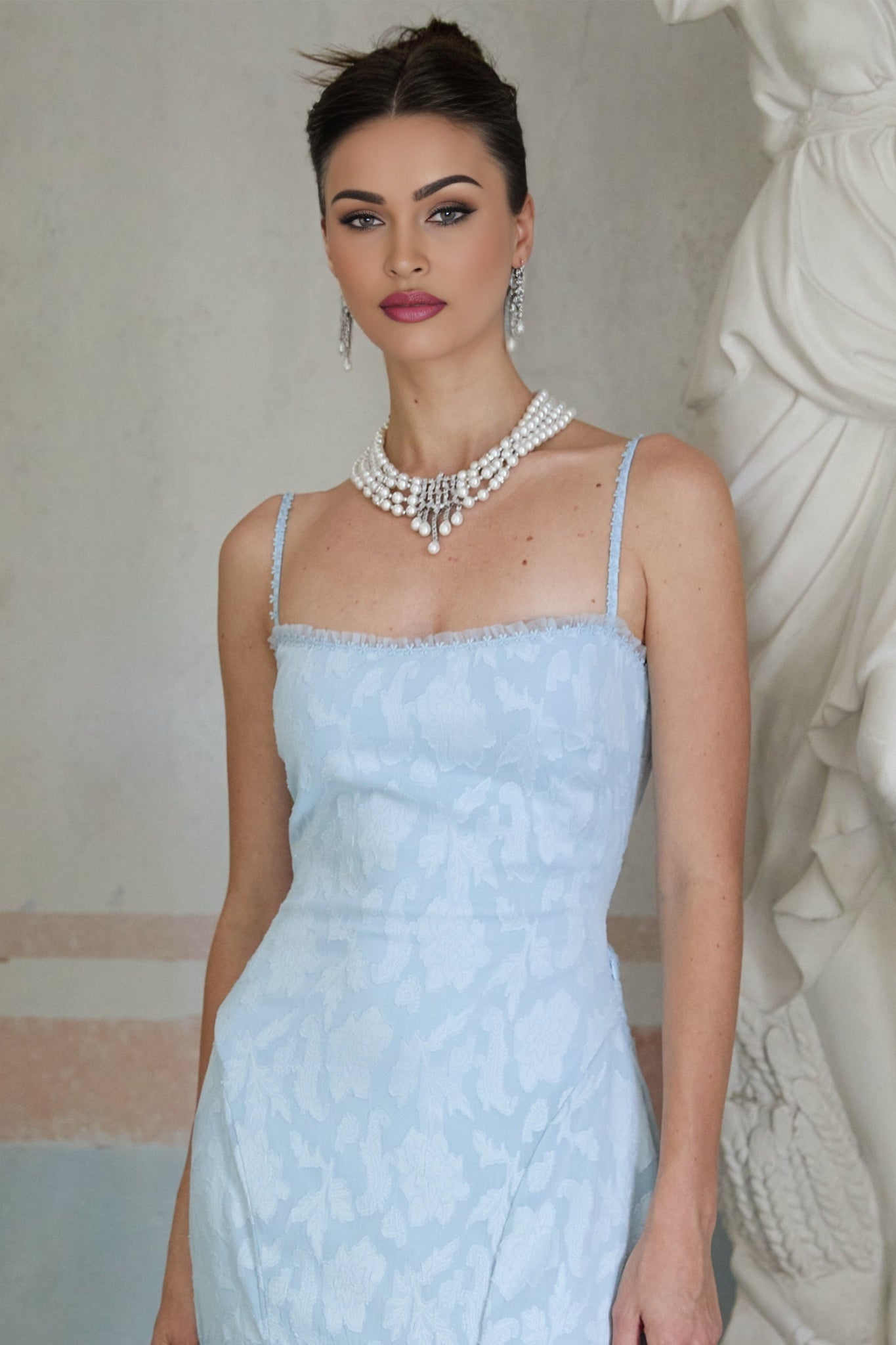 Woman wearing a delicate layered necklace with zircon stones and pearls named Catherine