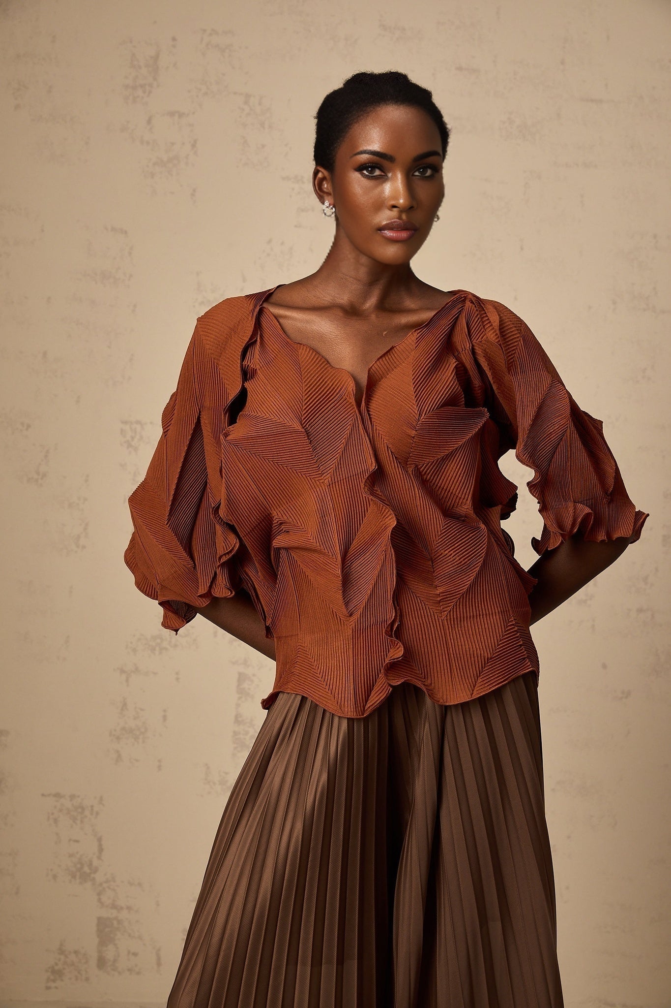 Woman wearing a demi brown matching set with creased texture top and skirt