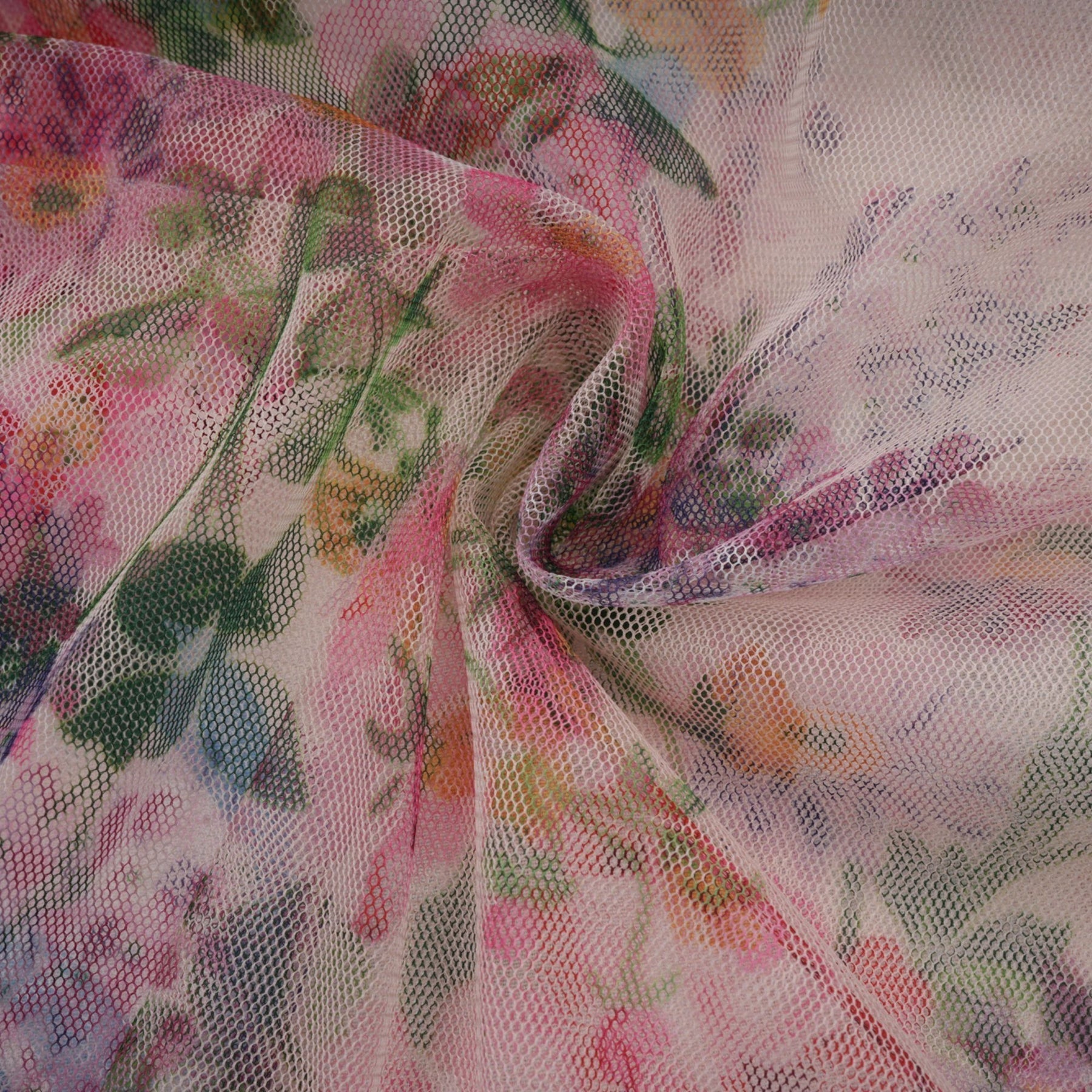 Woman wearing a floral patterned midi dress with ruffled tulle details and a feminine silhouette