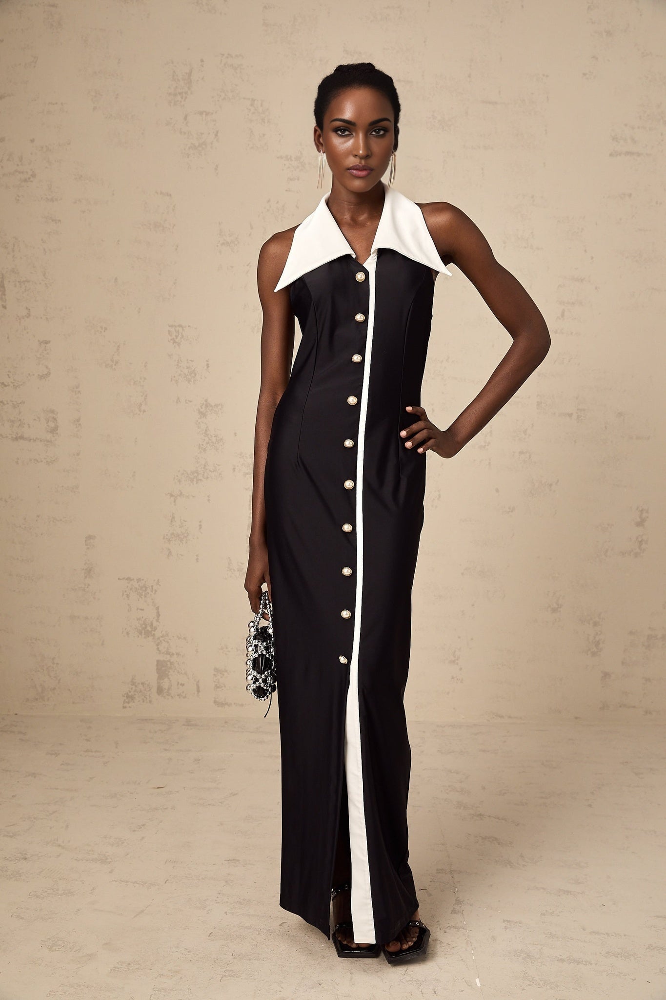 Woman wearing a long fitted maxi dress with colorblocked design featuring contrasting shades