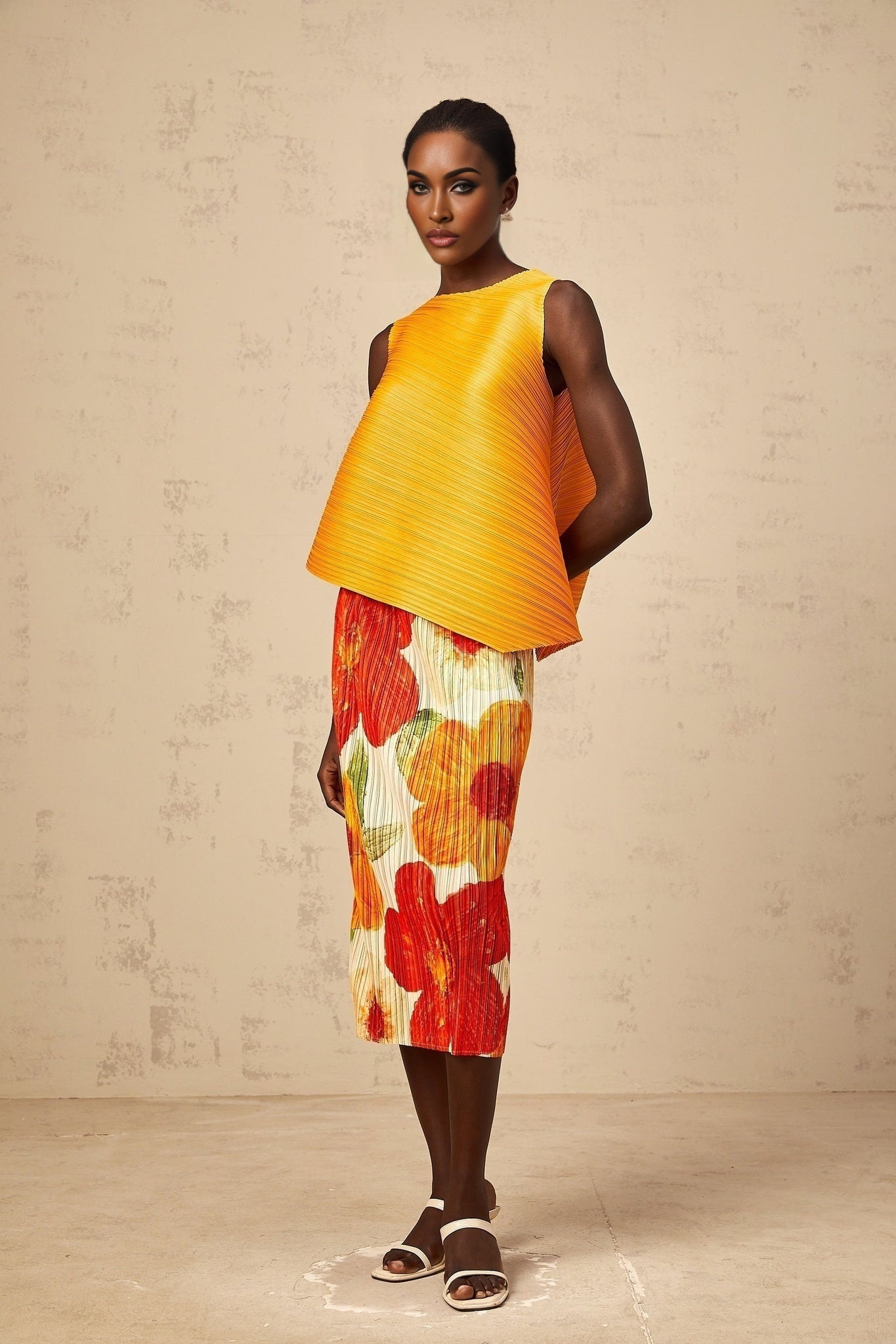 Woman wearing a matching amberorange crinkled top and skirt set standing against a plain background