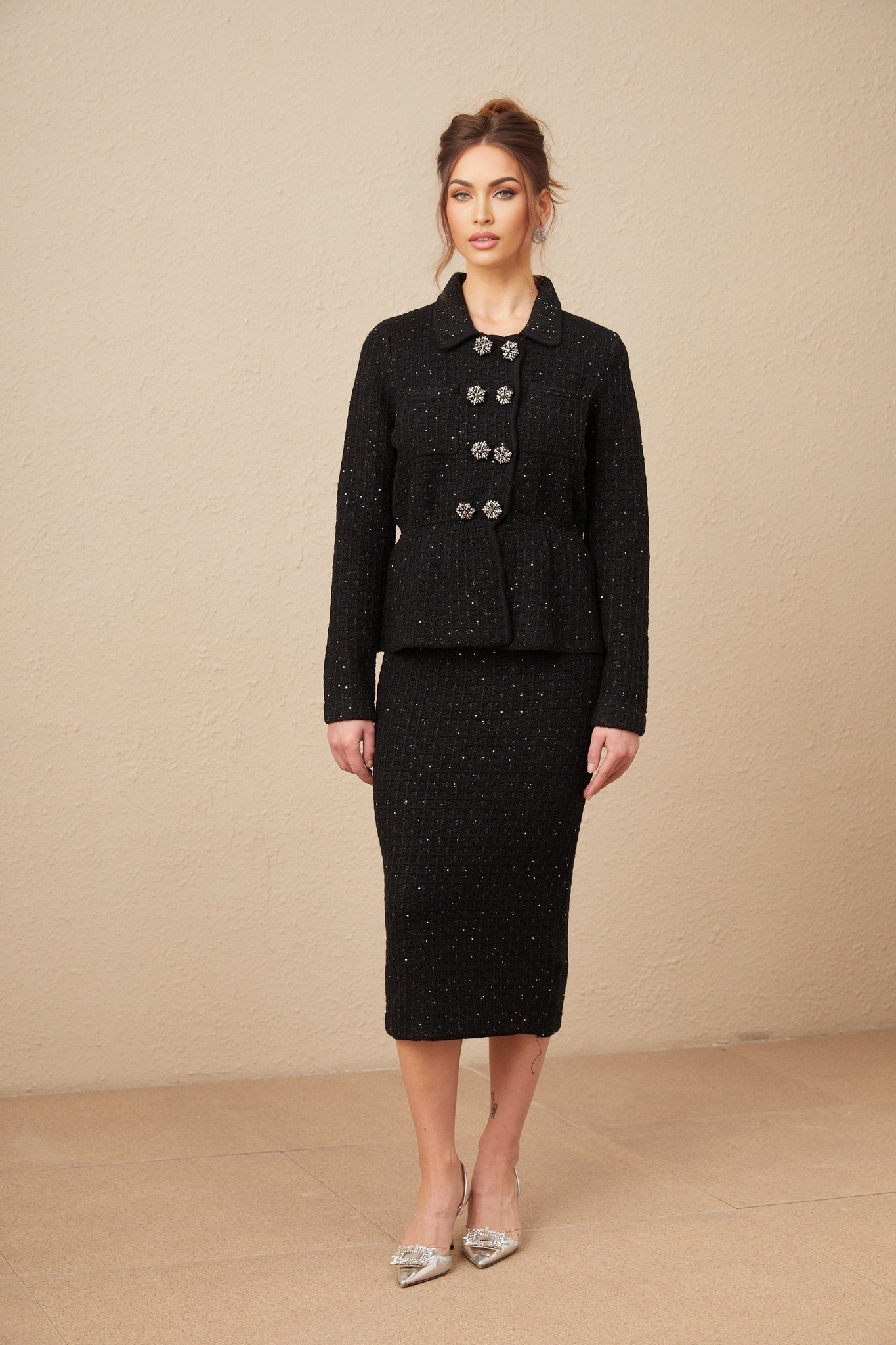 Woman wearing a matching sequined waffle knit jacket and skirt set in shimmering fabric