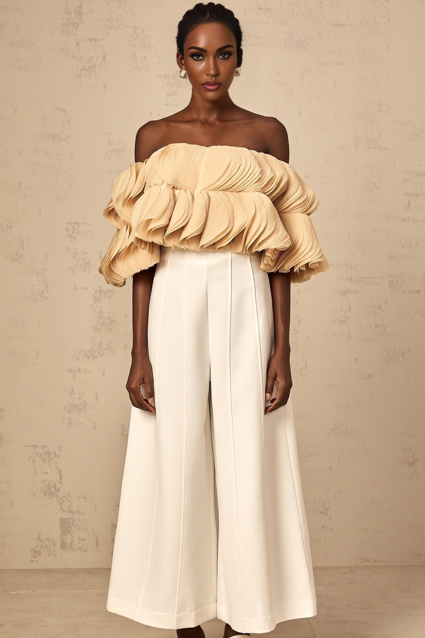 Woman wearing a neutral colored offshoulder cropped top with shirred design