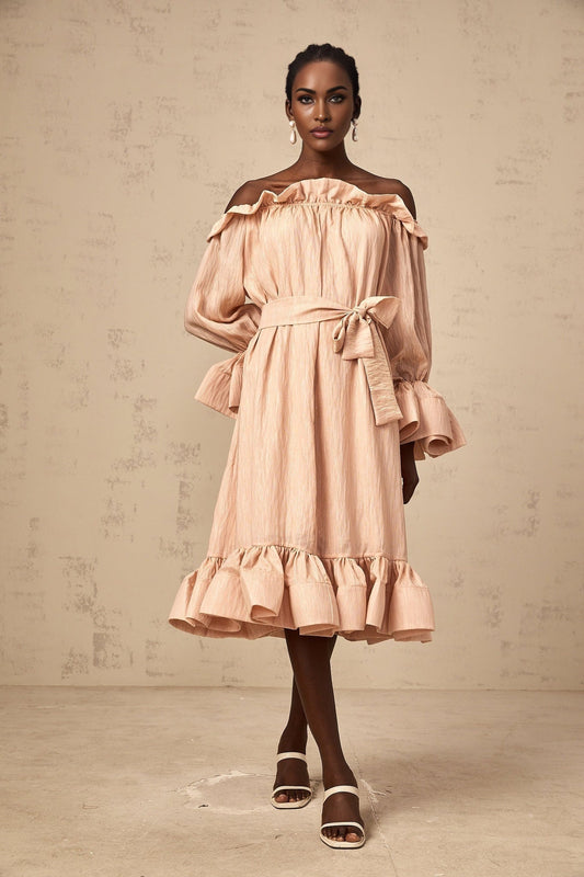 Woman wearing a pink midi dress with tied waist and ruffled details