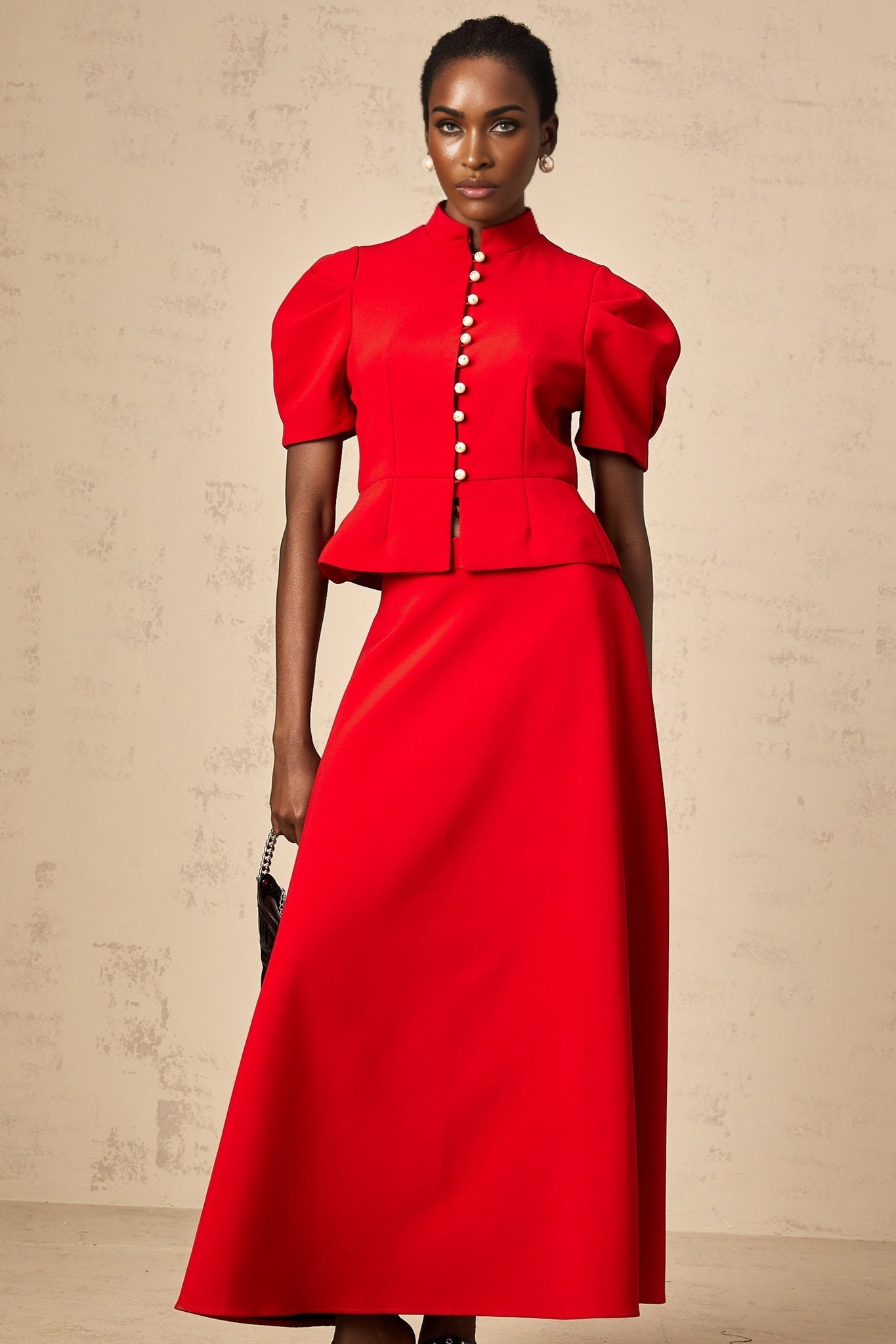 Woman wearing a red pleated blouse and matching skirt set Colette style outfit