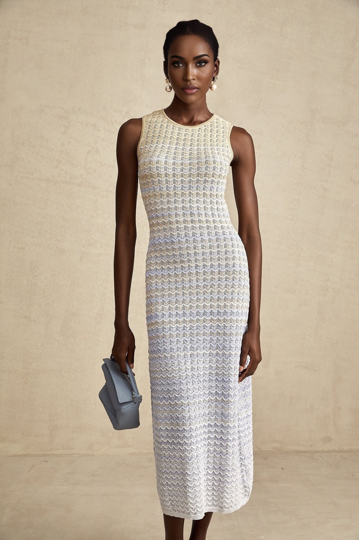 Woman wearing a ribbed knit midi dress with contrasting color details and a fitted silhouette